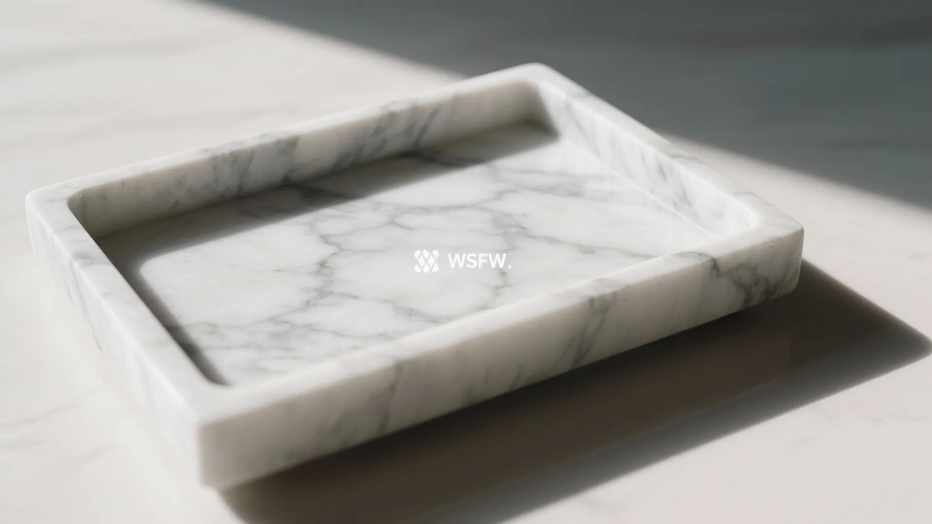 Macro of honed marble tray with dense veining and matte tactile texture.