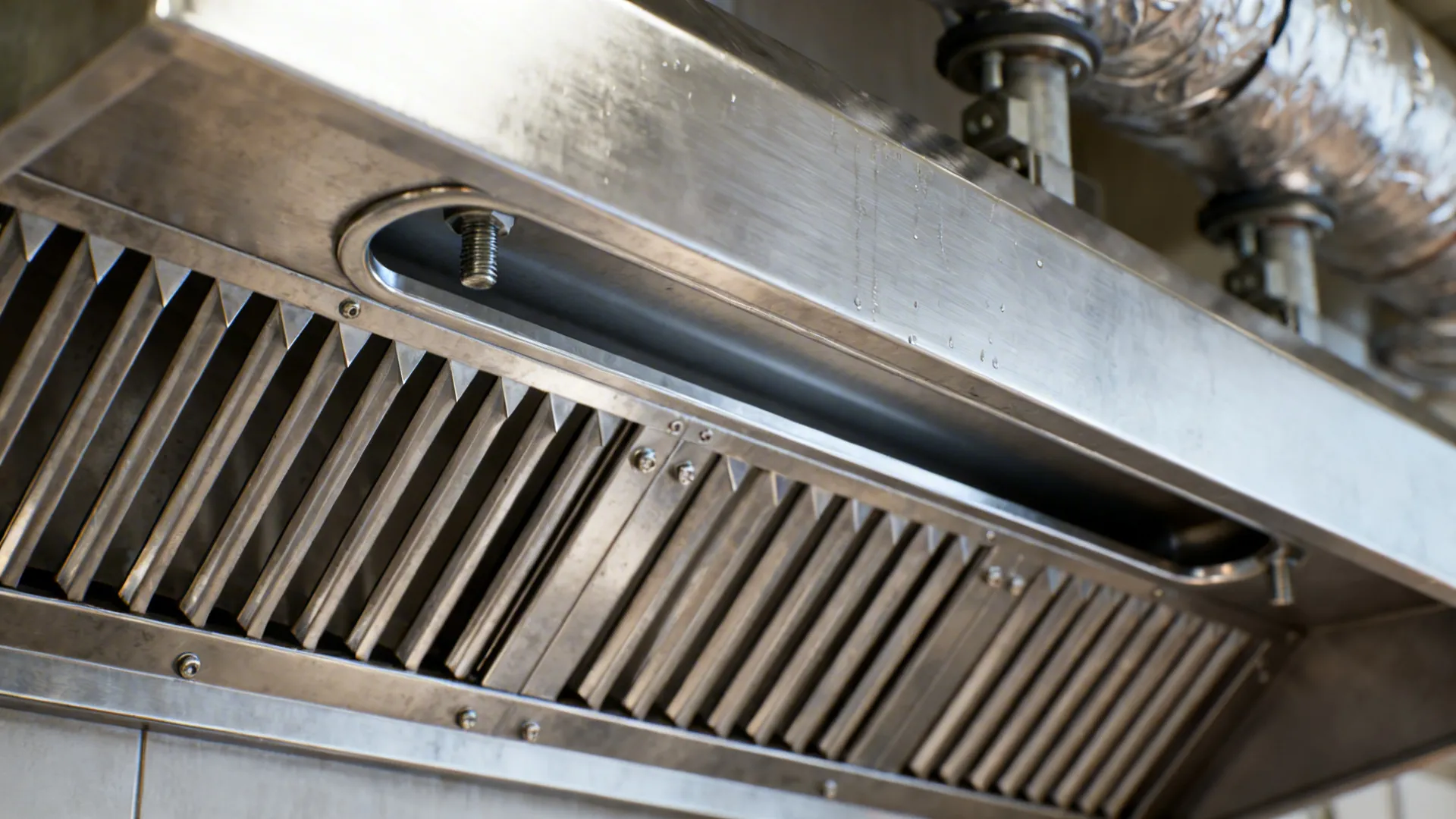 Macro view of a clean stainless baffle filter showing precise fins and channels.