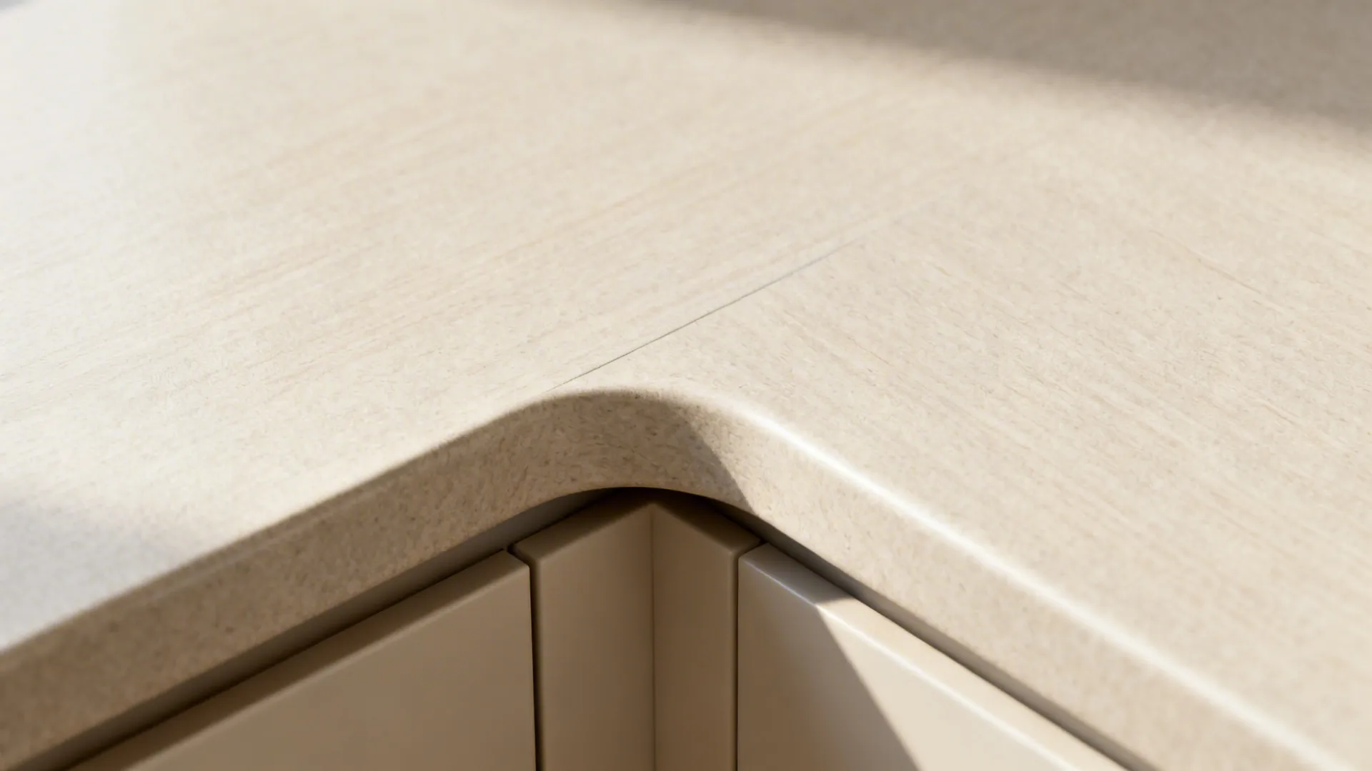 Macro of matte HPL countertop postformed edge with matching cabinet front in light beige.