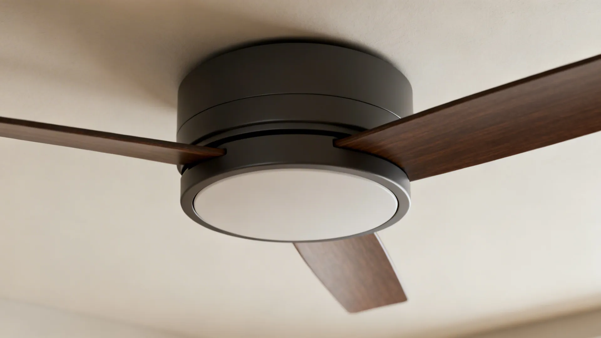 Close up of a modern black ceiling fan with wooden blades and integrated round light fixture