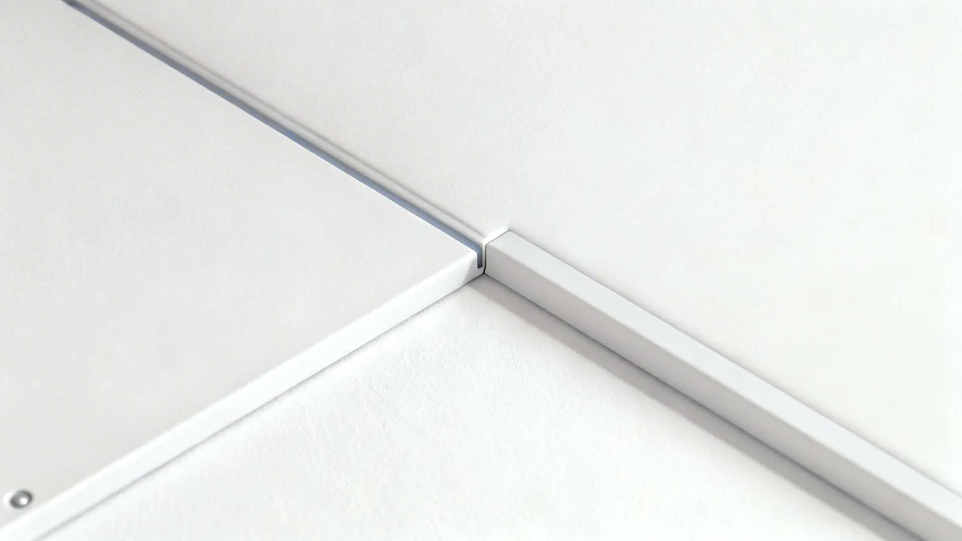 Macro of a PVC inset ceiling seam with a precise chamfer and clean 3 mm gap.