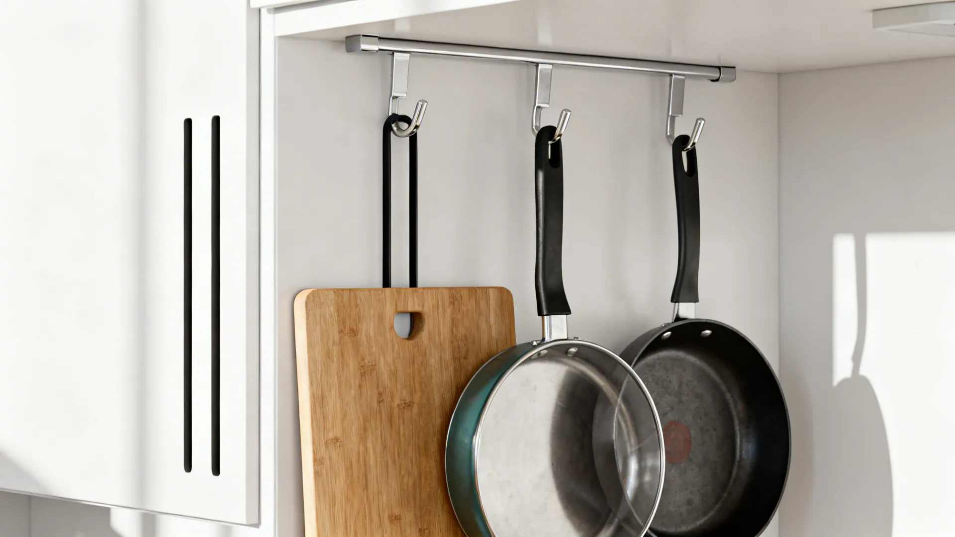 Inside-cabinet door lid hanger with organized lids and small pans.