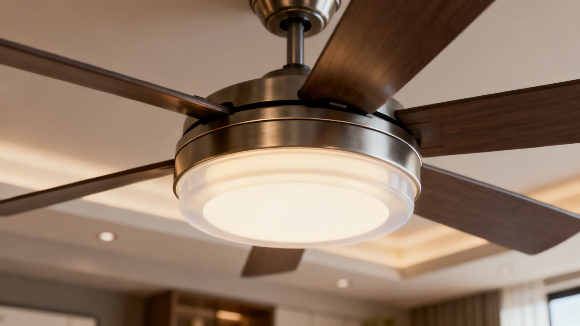 Close-up of a large ceiling fan with integrated diffused LED light and warm glow.