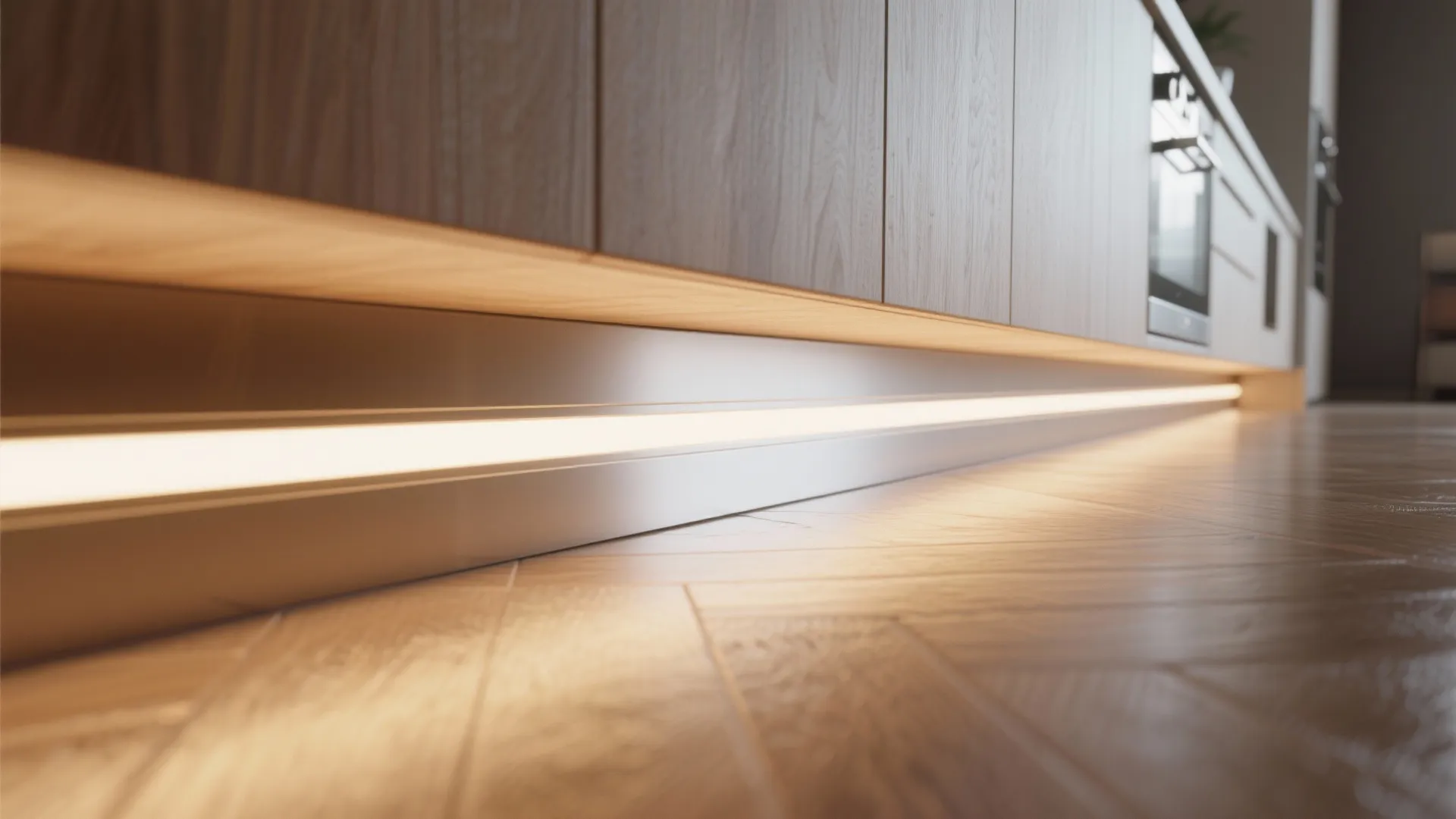 Macro view of warm toe-kick LED strip under a kitchen island creating a soft floor glow.