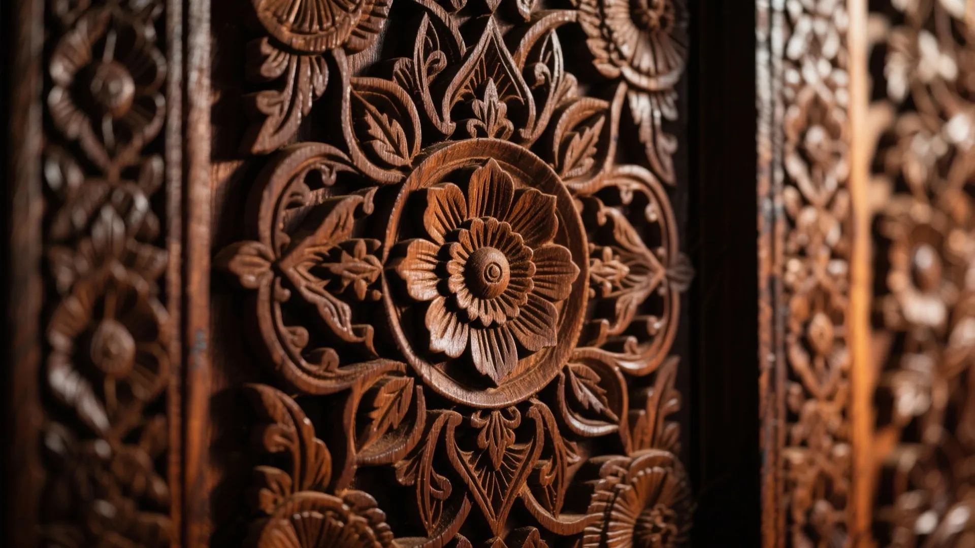 Close up of an intricate dark wood flower carving on a decorative interior wall panel
