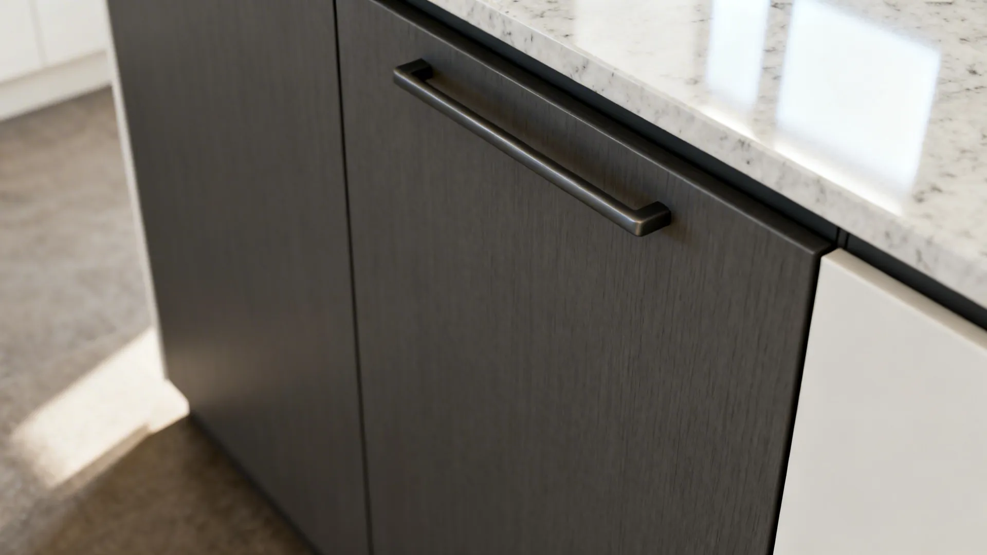 Close up of dark textured kitchen cabinet door with black handle and white marble stone