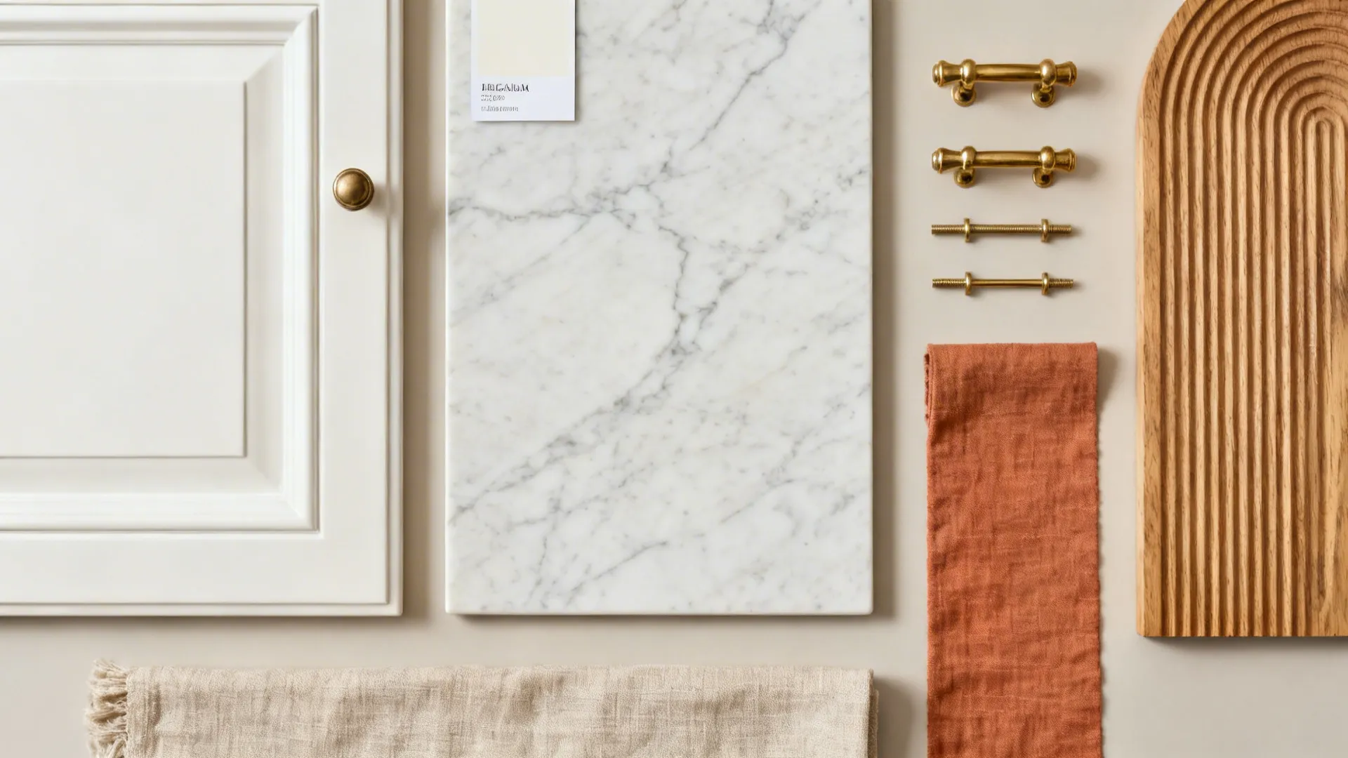 Top-down flat lay of warm white paint, honed marble, veined porcelain, brass hardware, oak, and terracotta linen.