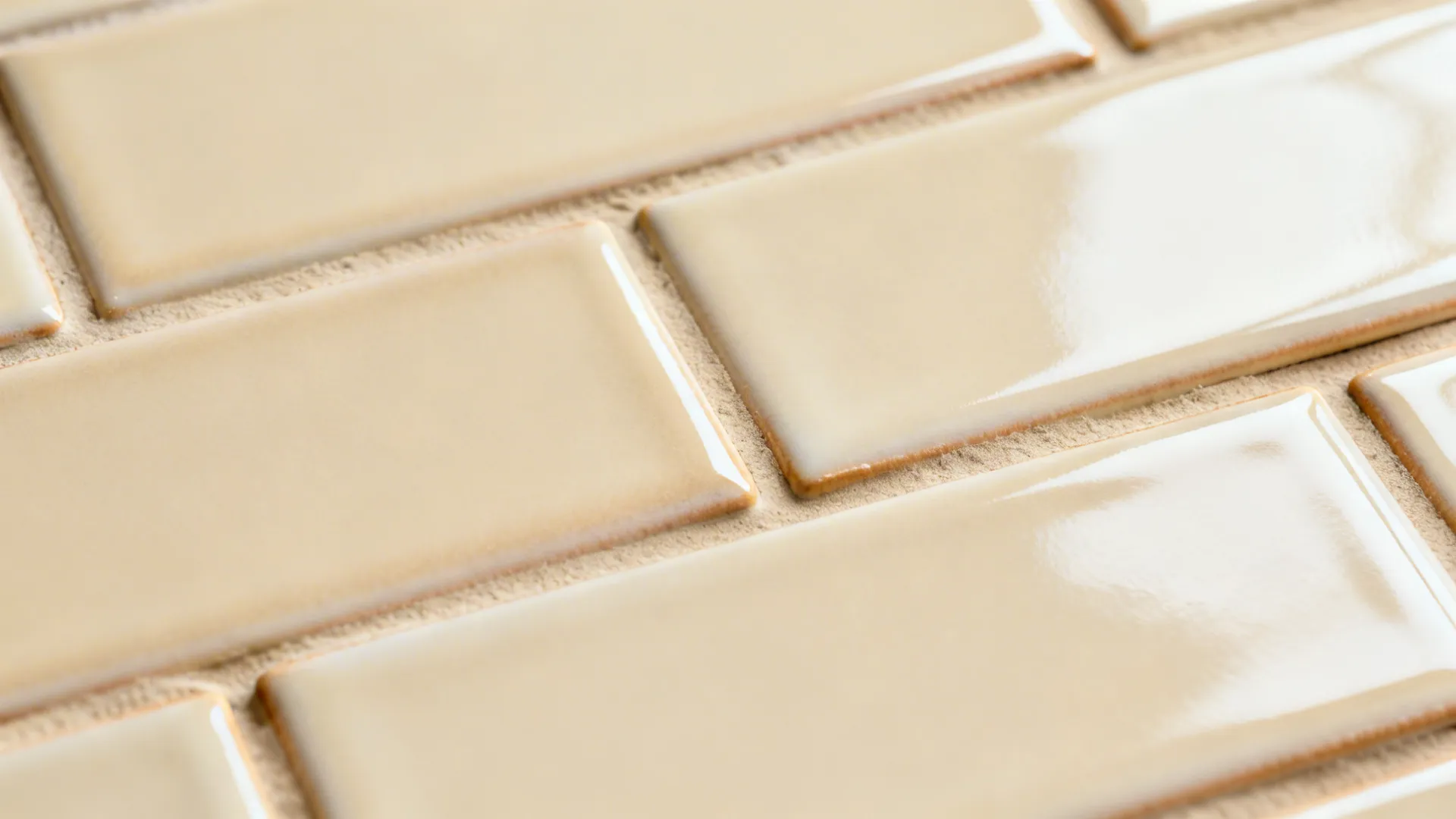 Macro of satin ivory subway tiles with tone-on-tone grout and gentle glaze variation.