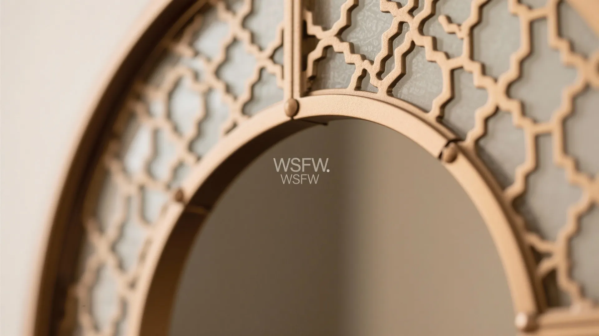 Golden round frame with a geometric pattern overlay showing a simple wall in the background