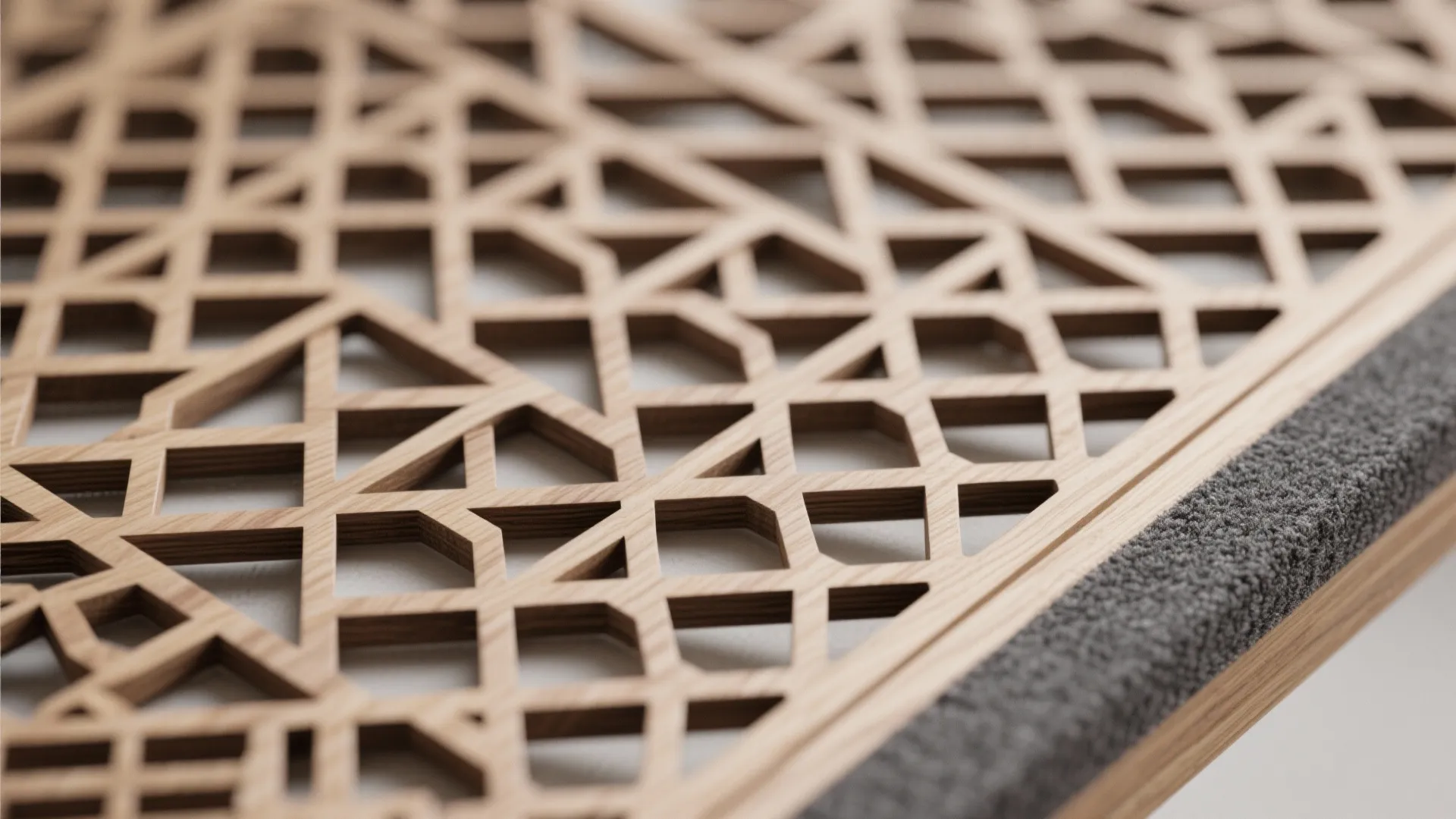 Detailed view of light wood screen with complex geometric patterns and many small square cutouts