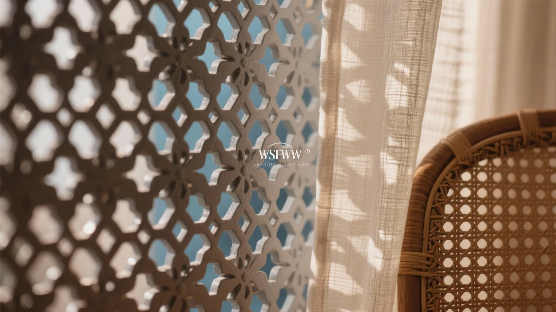 Macro of powder-coated jaali pattern, rattan weave, and linen sheer in soft light.