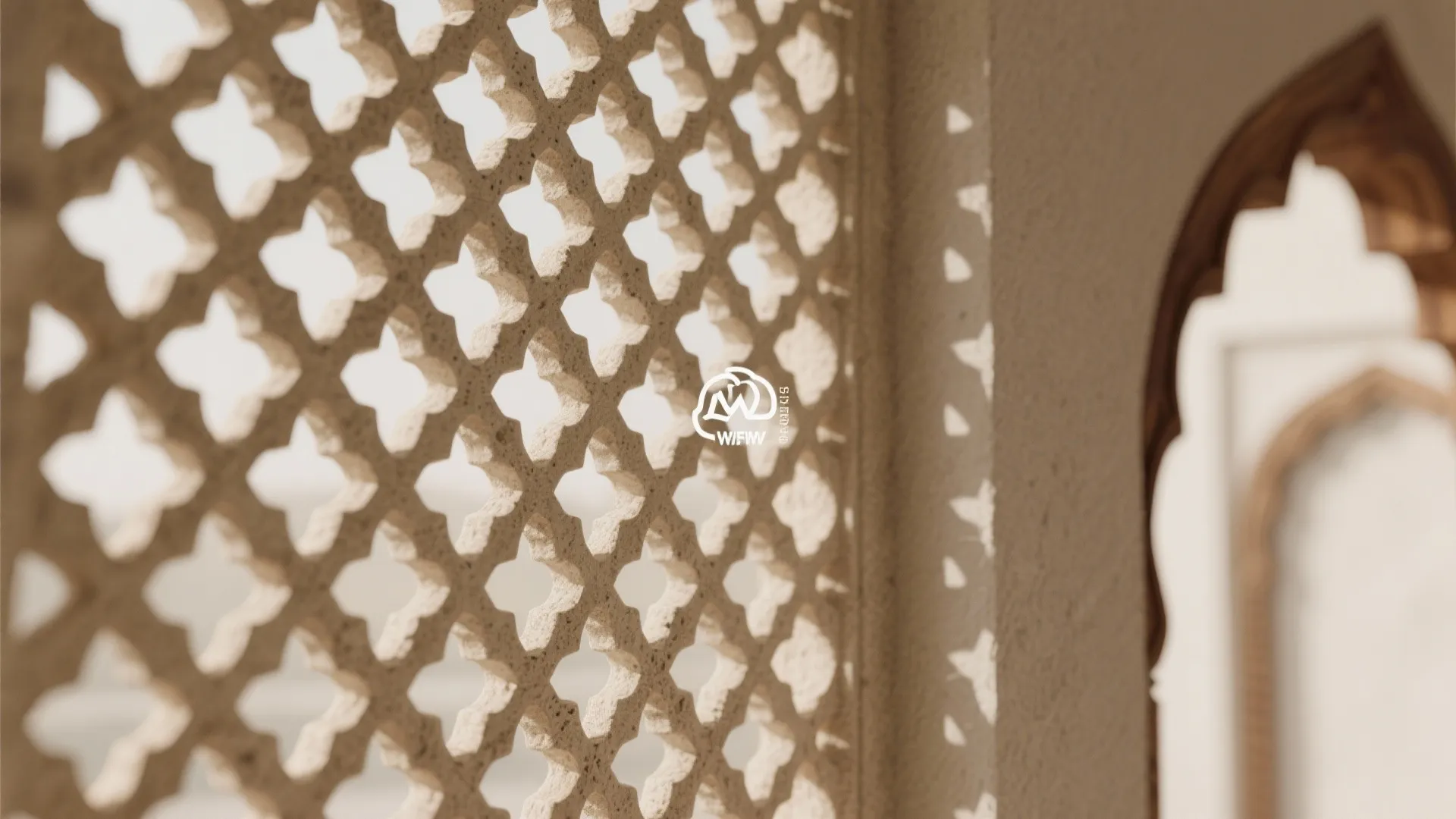 Macro of sandstone jaali with soft light and patterned shadows.