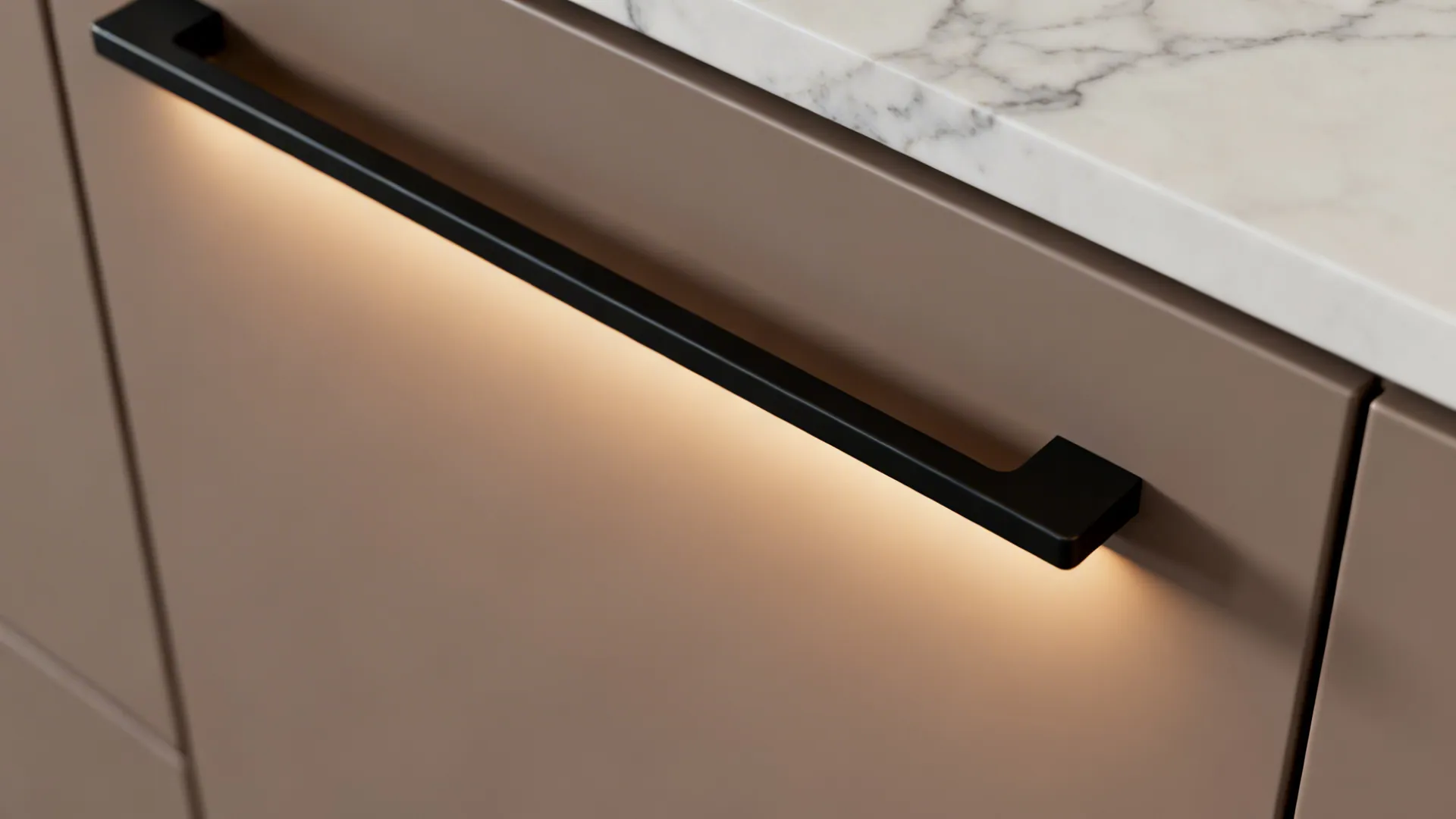 Close-up of a J-pull drawer with a contrasting black rail and matte taupe finish.