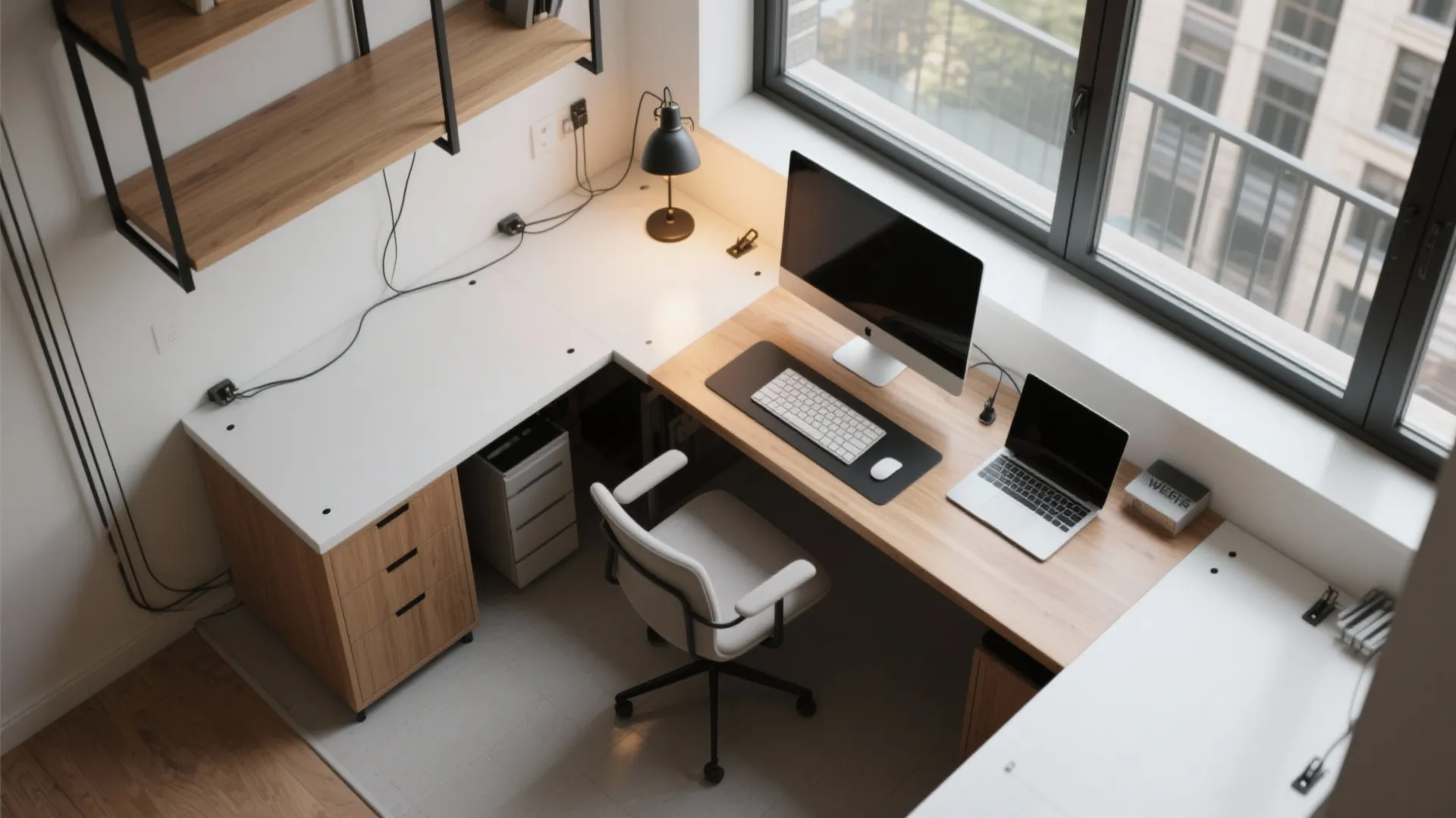 Top down view of a white and wood home office desk with computer and office chair
