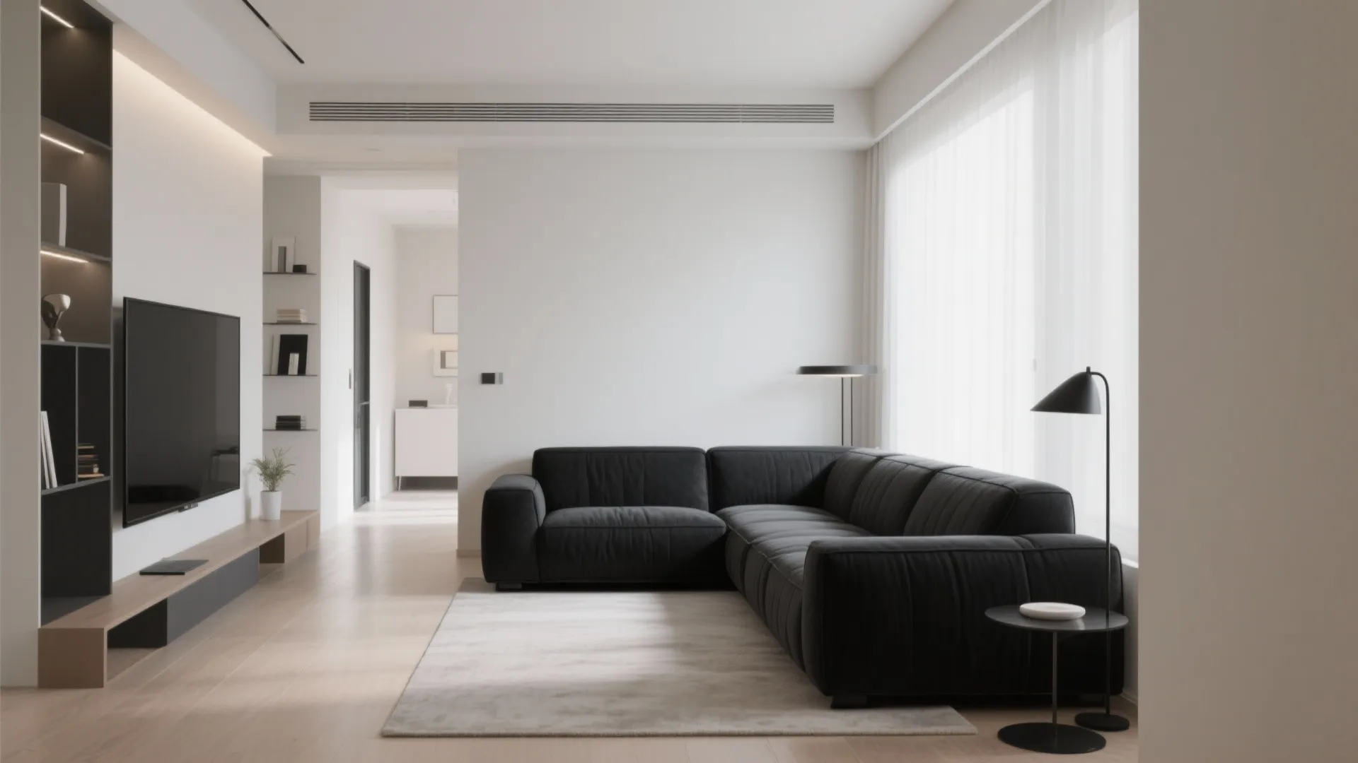 L-shaped black sofa in a narrow, modern living room