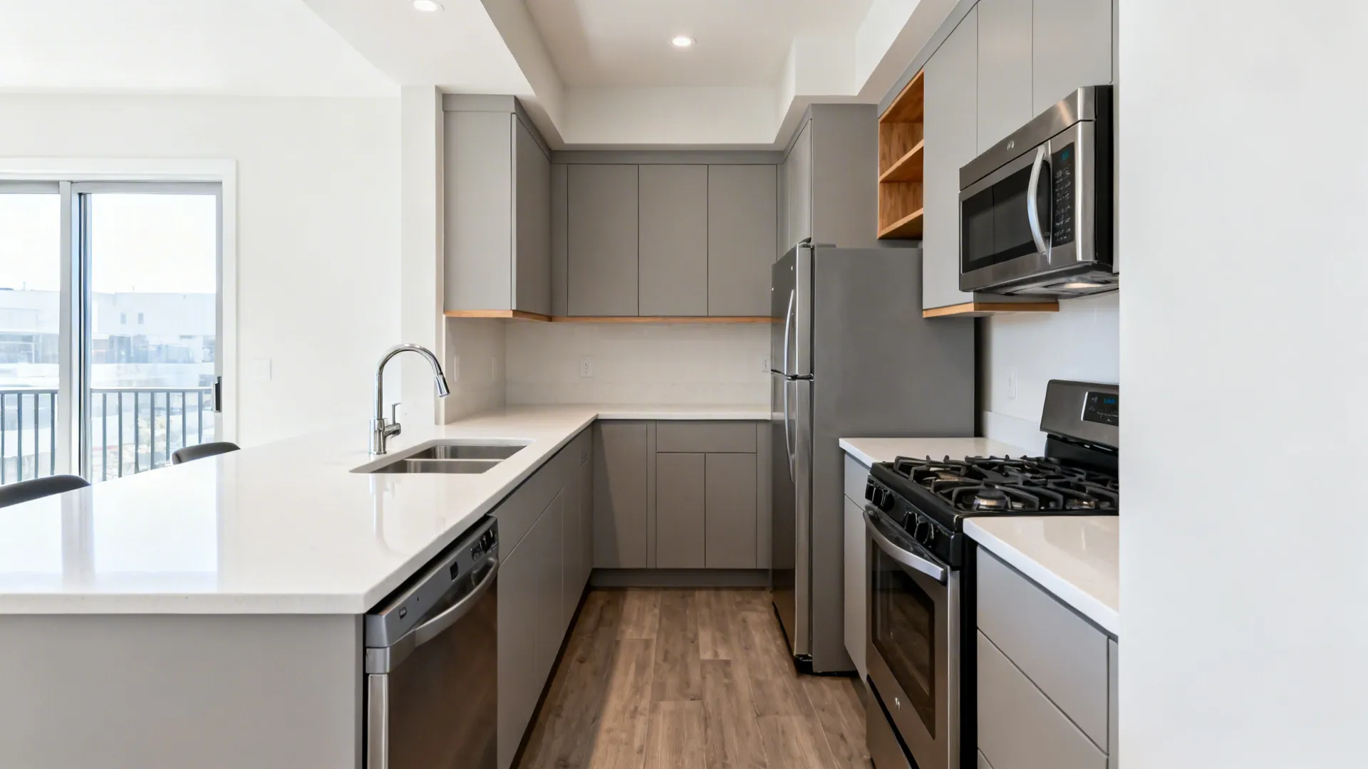 Compact L-shaped kitchen with uninterrupted countertop, clear work triangle, and counter-depth appliances.