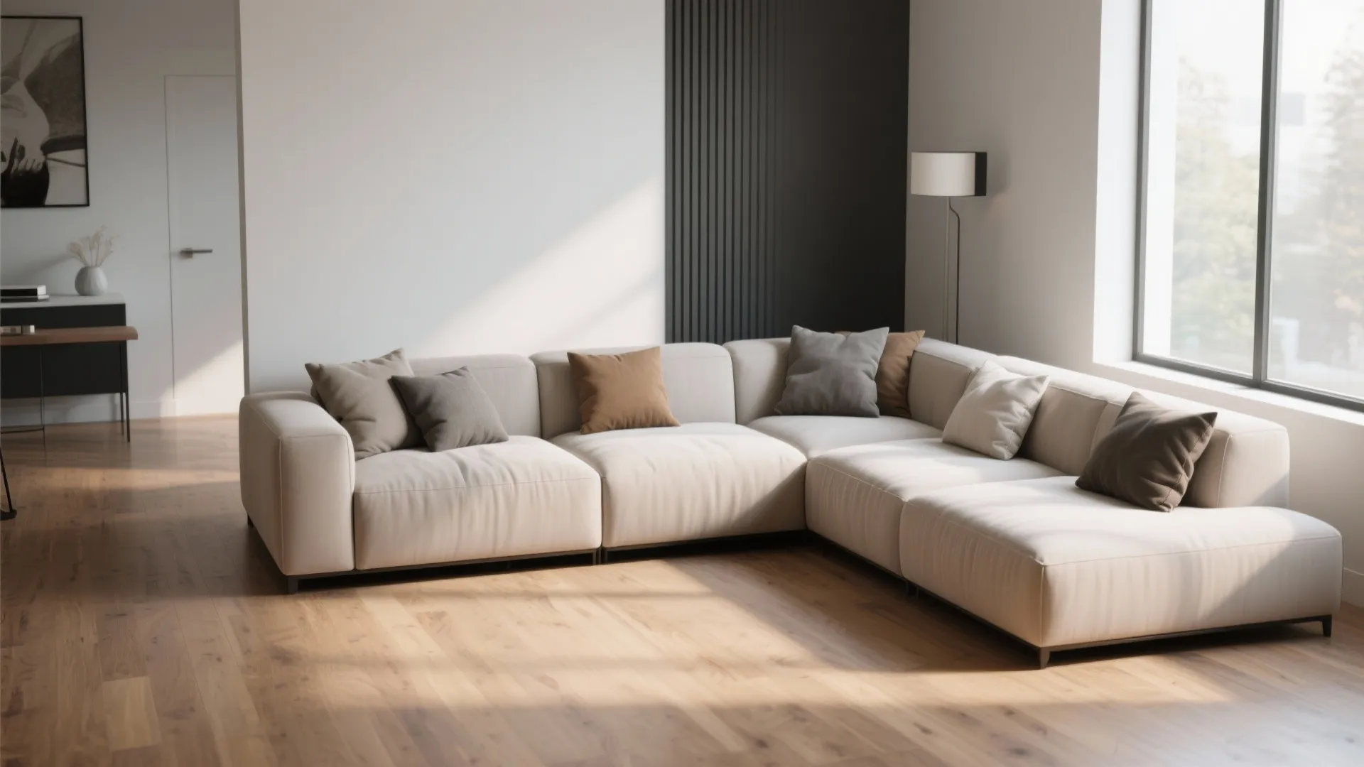 Modern white corner sofa with grey pillows on wooden floor in bright living room interior