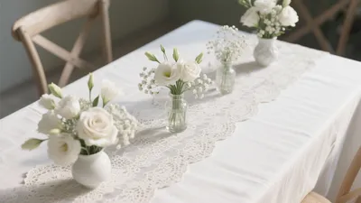 Elegant White Dining Table Setting with Lace and Flowers