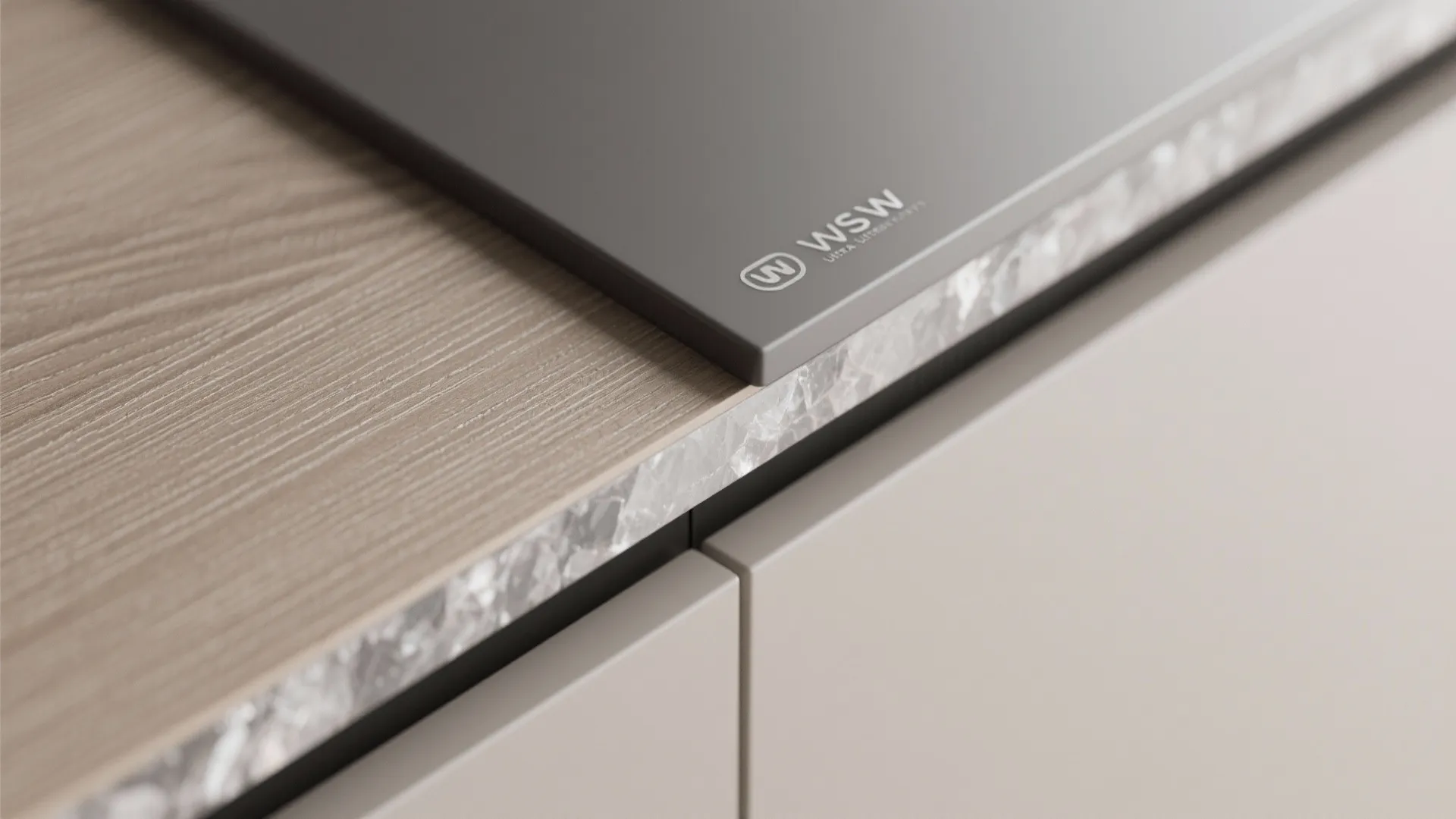 Close up view of wood countertop texture next to dark grey stone surface and cabinet