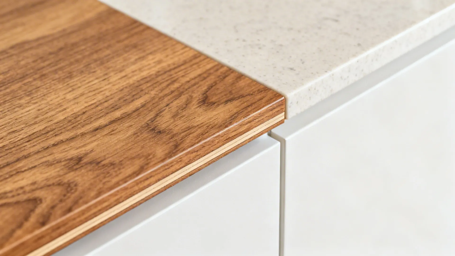 Macro of textured woodgrain laminate with clean edge banding beside matte white.