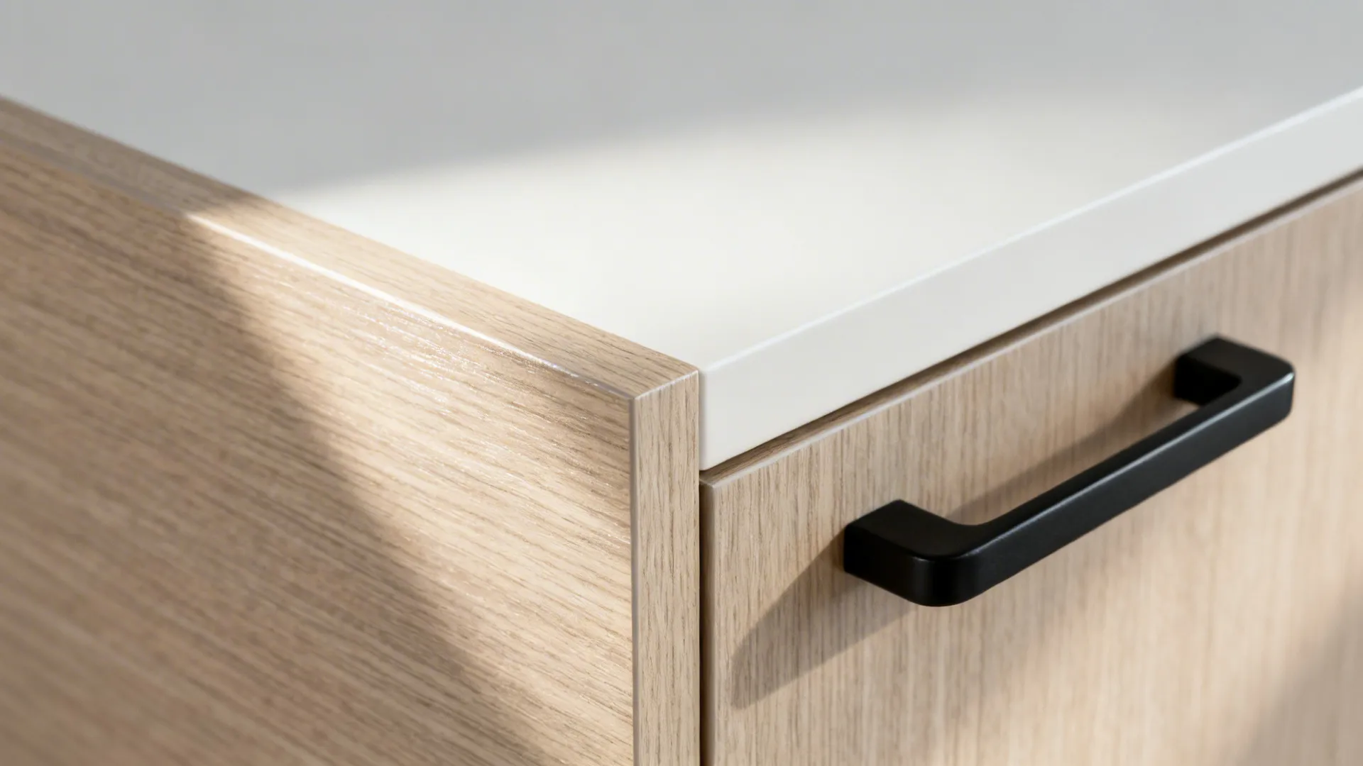 Macro of wood-look laminate texture beside a matte off-white cabinet.