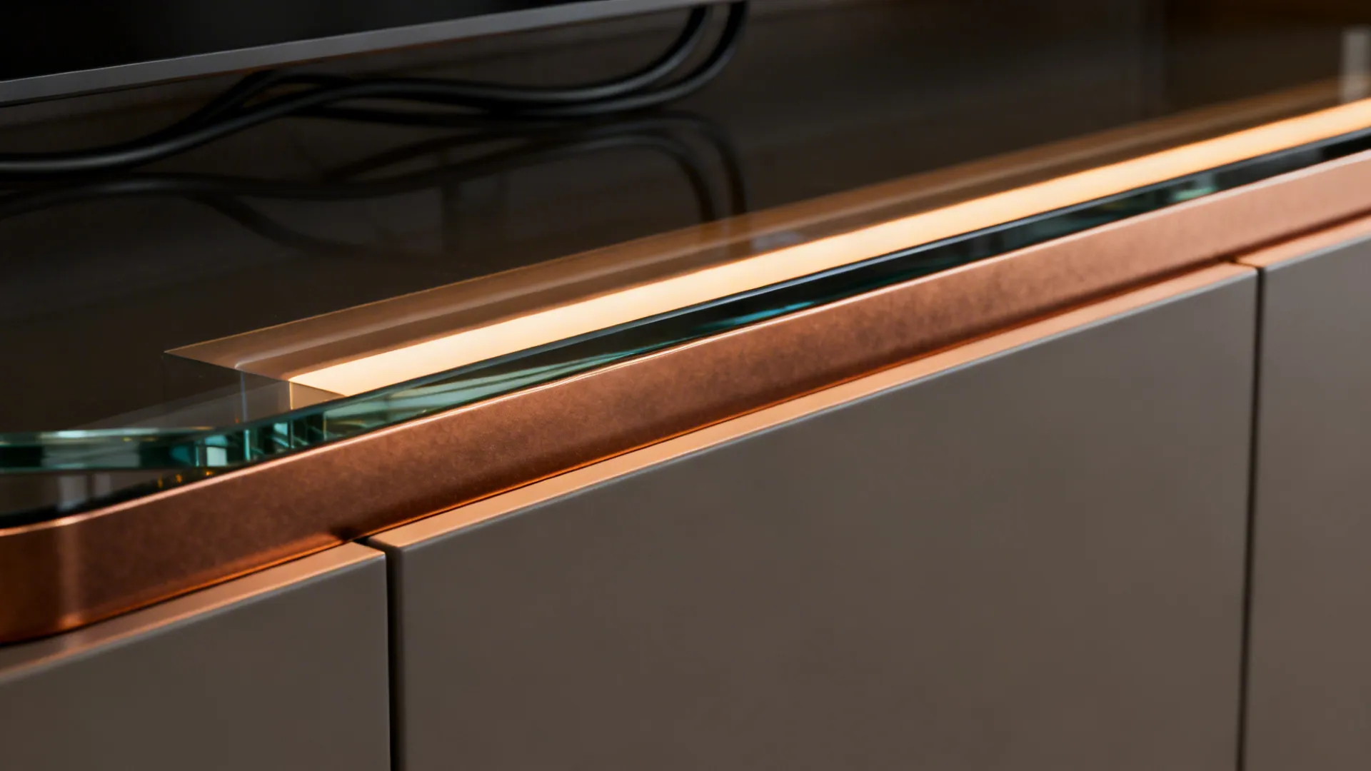 Macro edge of bronze laminated glass with visible interlayer and warm LED diffuser channel.