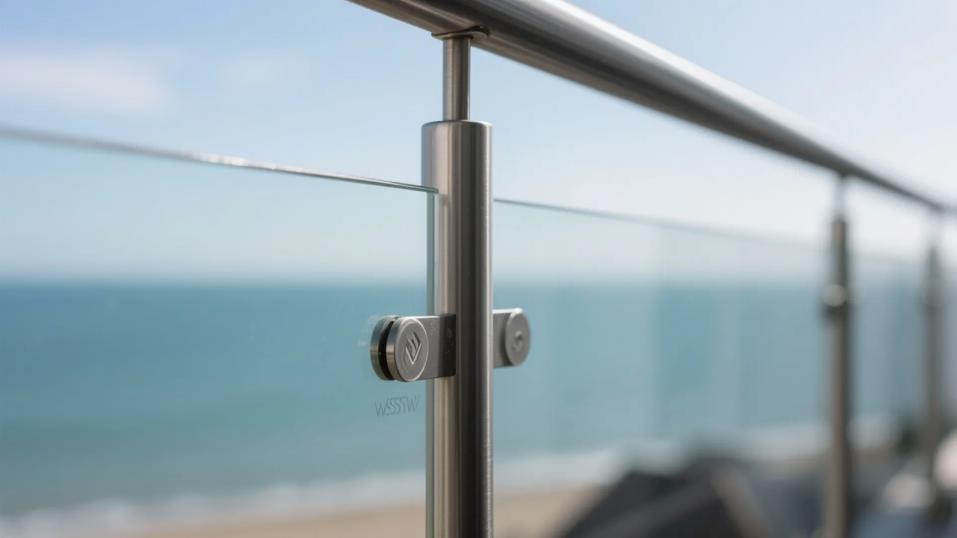 Macro of laminated glass balustrade with satin stainless clamps and polished edge.