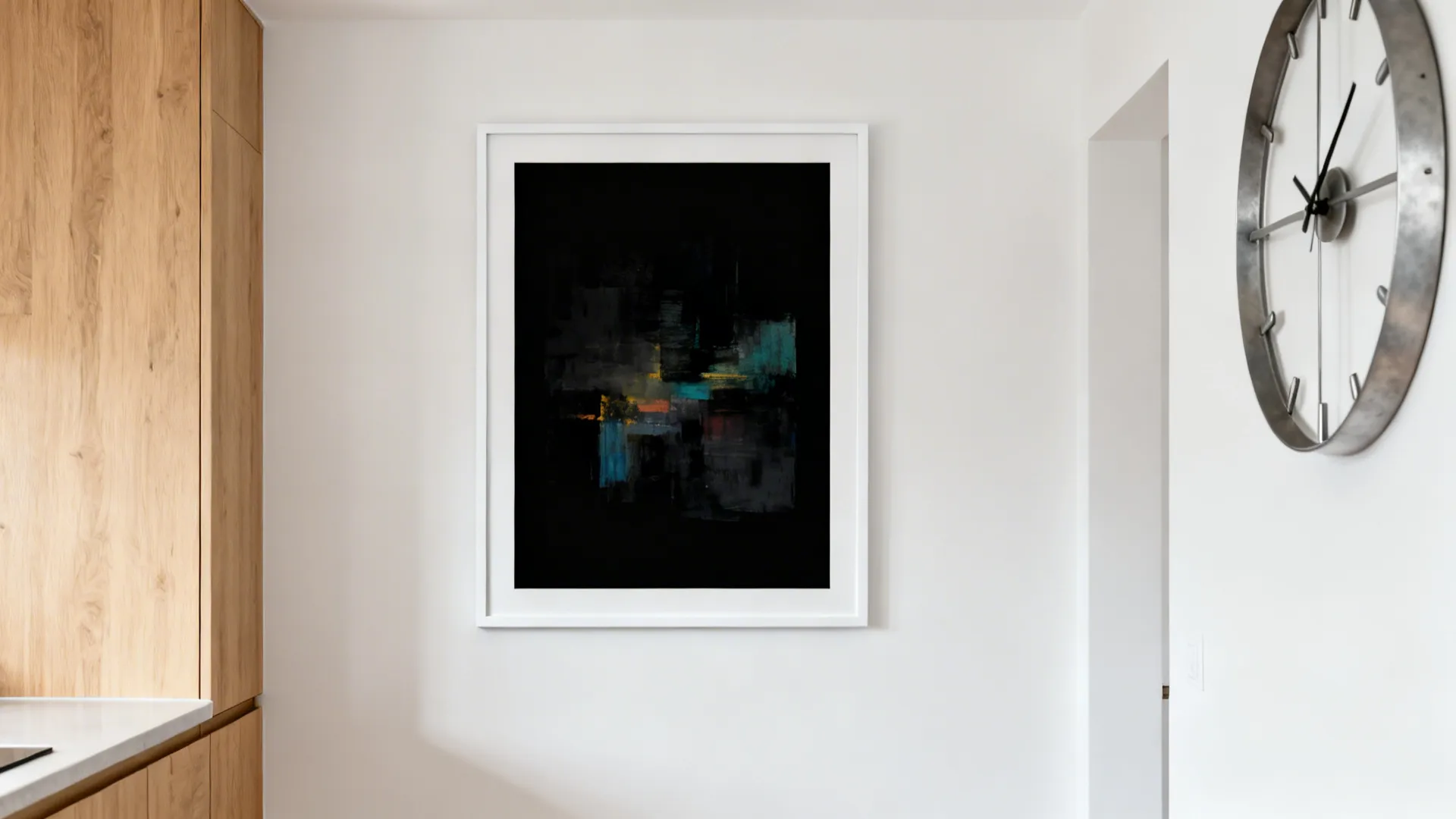 Large black-framed abstract artwork as a clean focal point on a modern kitchen wall.