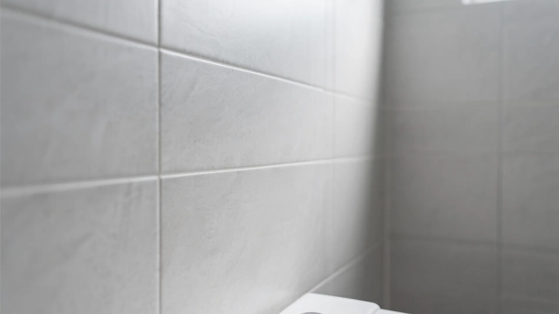 Close-up of large light grey tiles creating a spacious feel