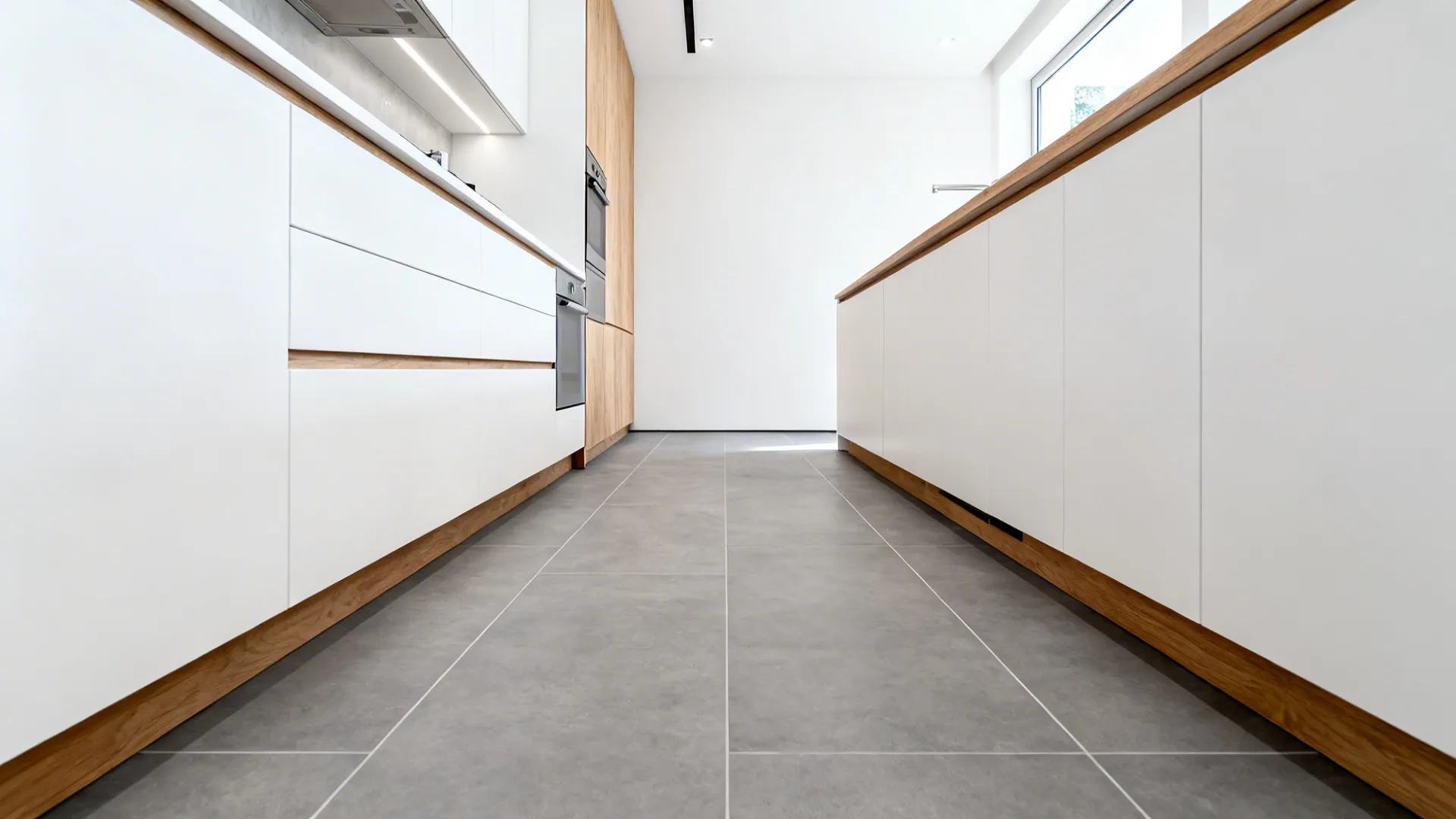 One-wall kitchen with 24x48 grey tiles laid lengthwise and minimal grout lines.