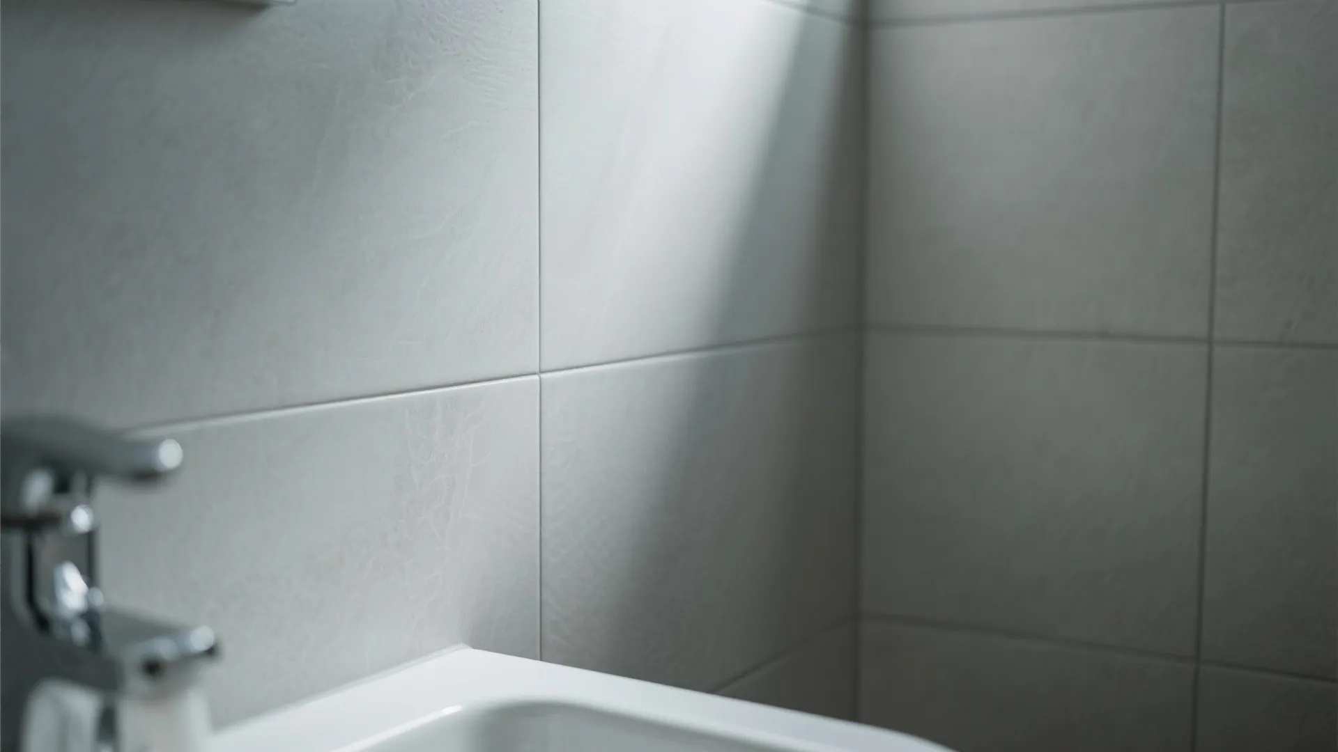 Close-up of large light grey bathroom floor tiles