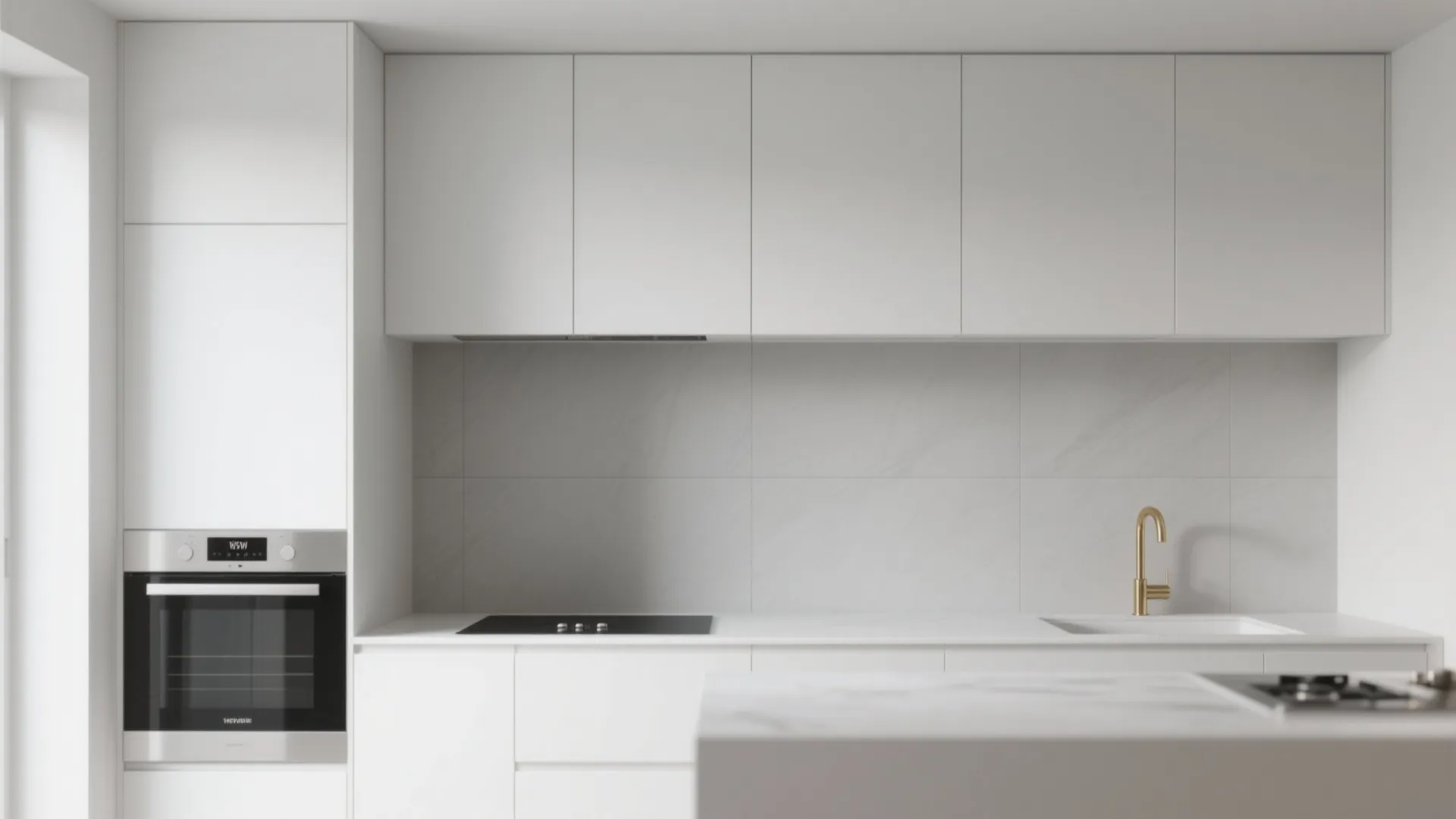 Minimalist white kitchen featuring matte grey wall tiles, gold faucet, built-in oven, and induction stove