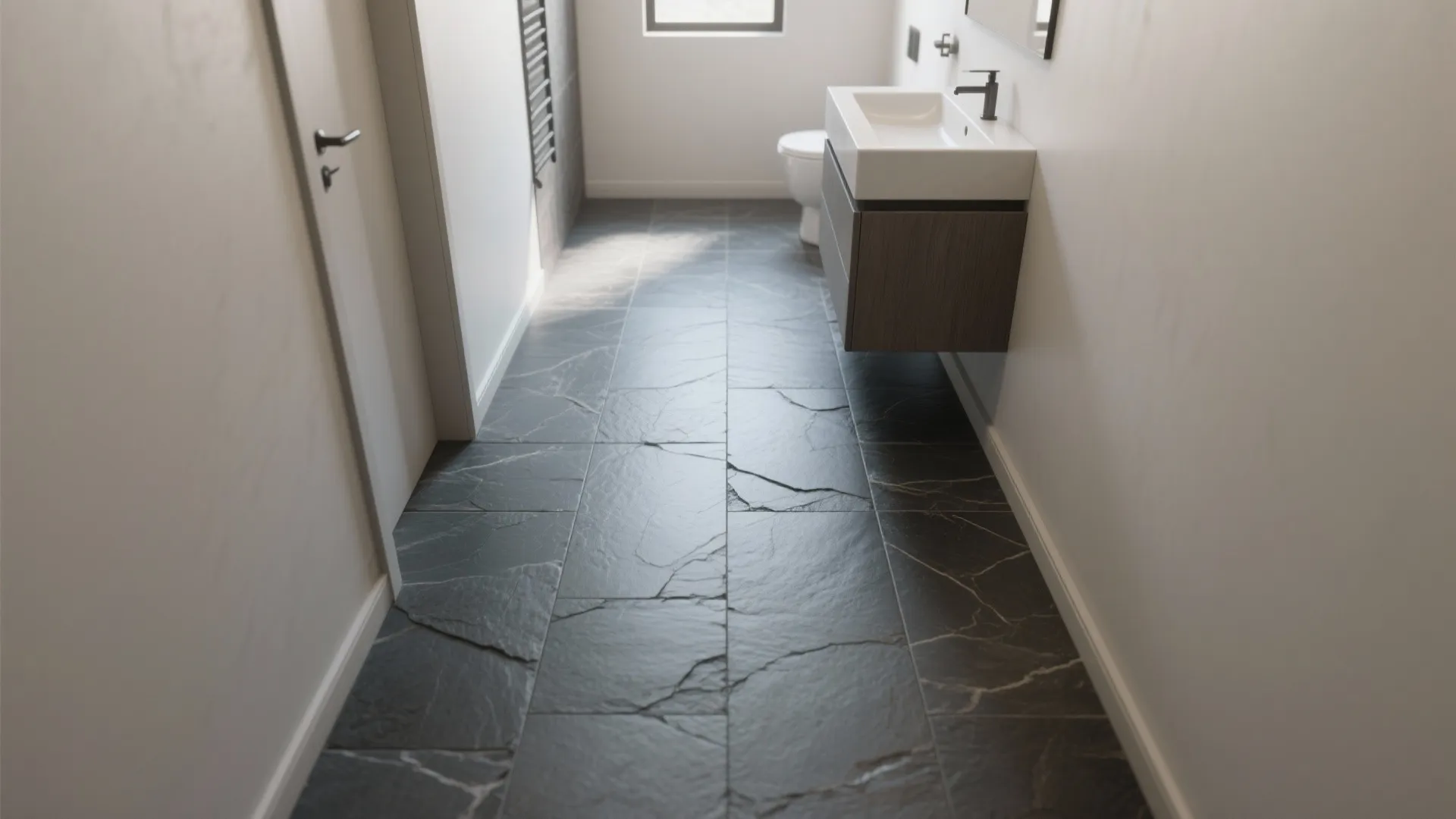 Modern bathroom with dark grey stone floor tiles white walls floating cabinet and ceramic white sink