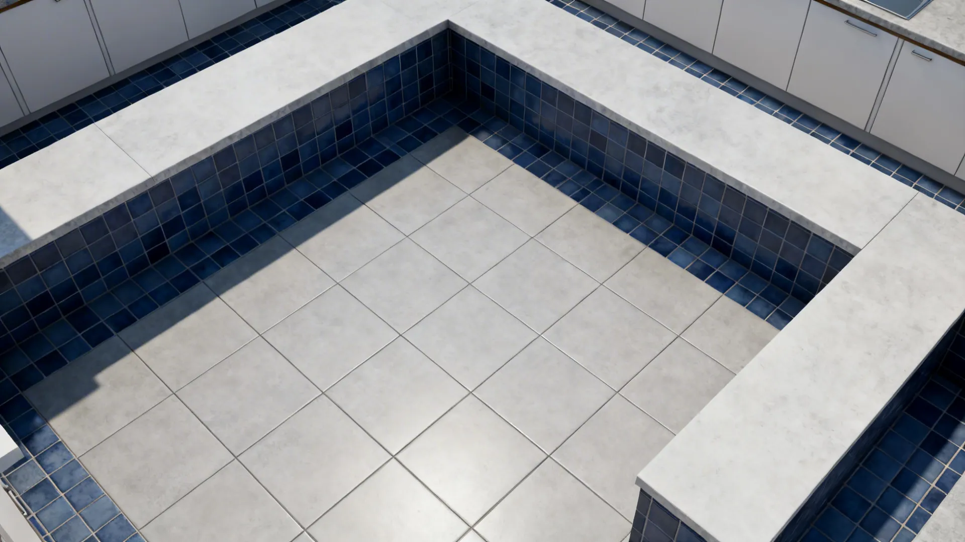 Top-down view showing large-format light gray tiles with ink blue wall zones.