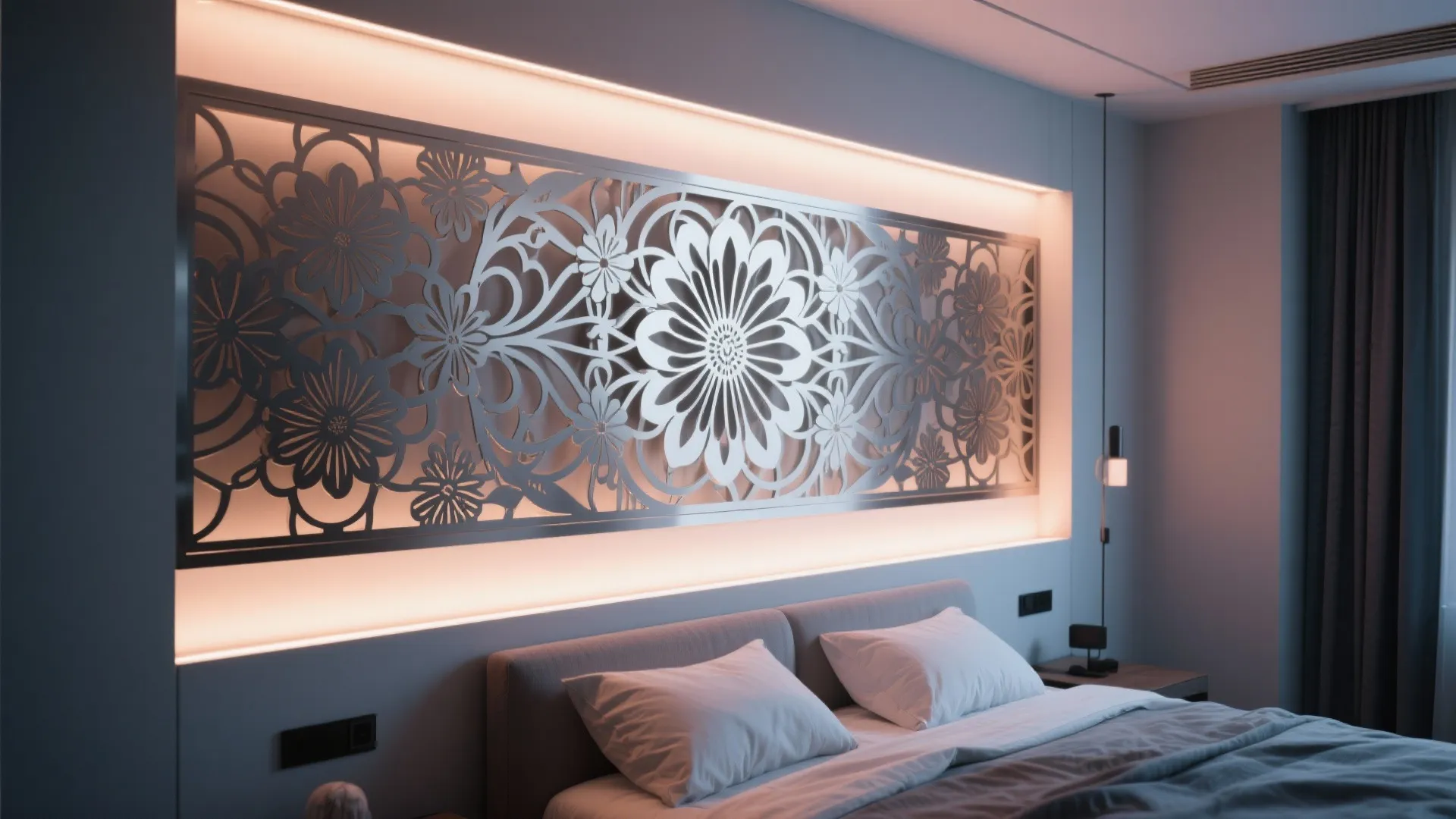 Bedroom interior featuring a floral wall panel with warm backlight above a comfortable grey bed