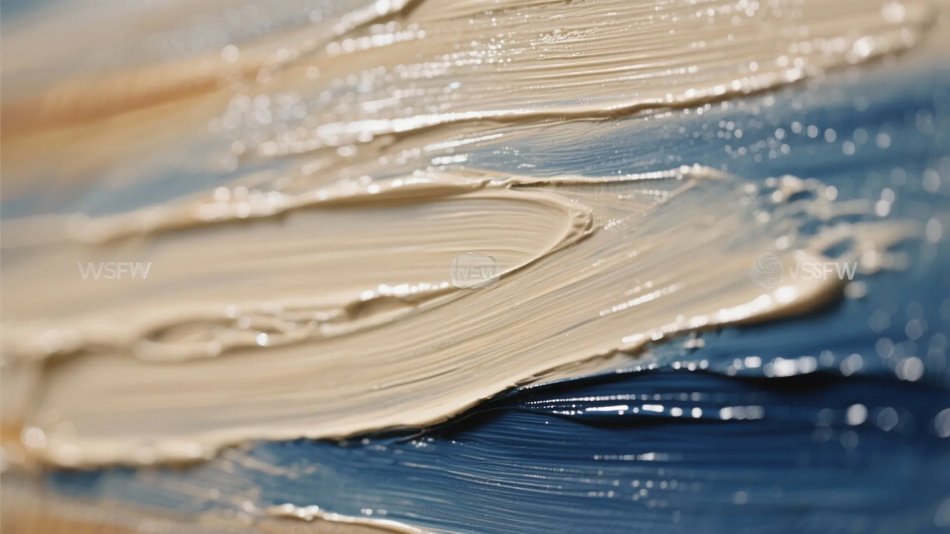 Close up view of thick beige and blue oil paint texture strokes on a canvas