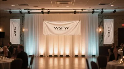 Elegant Event Hall with Draped Backdrop and Stage Lighting