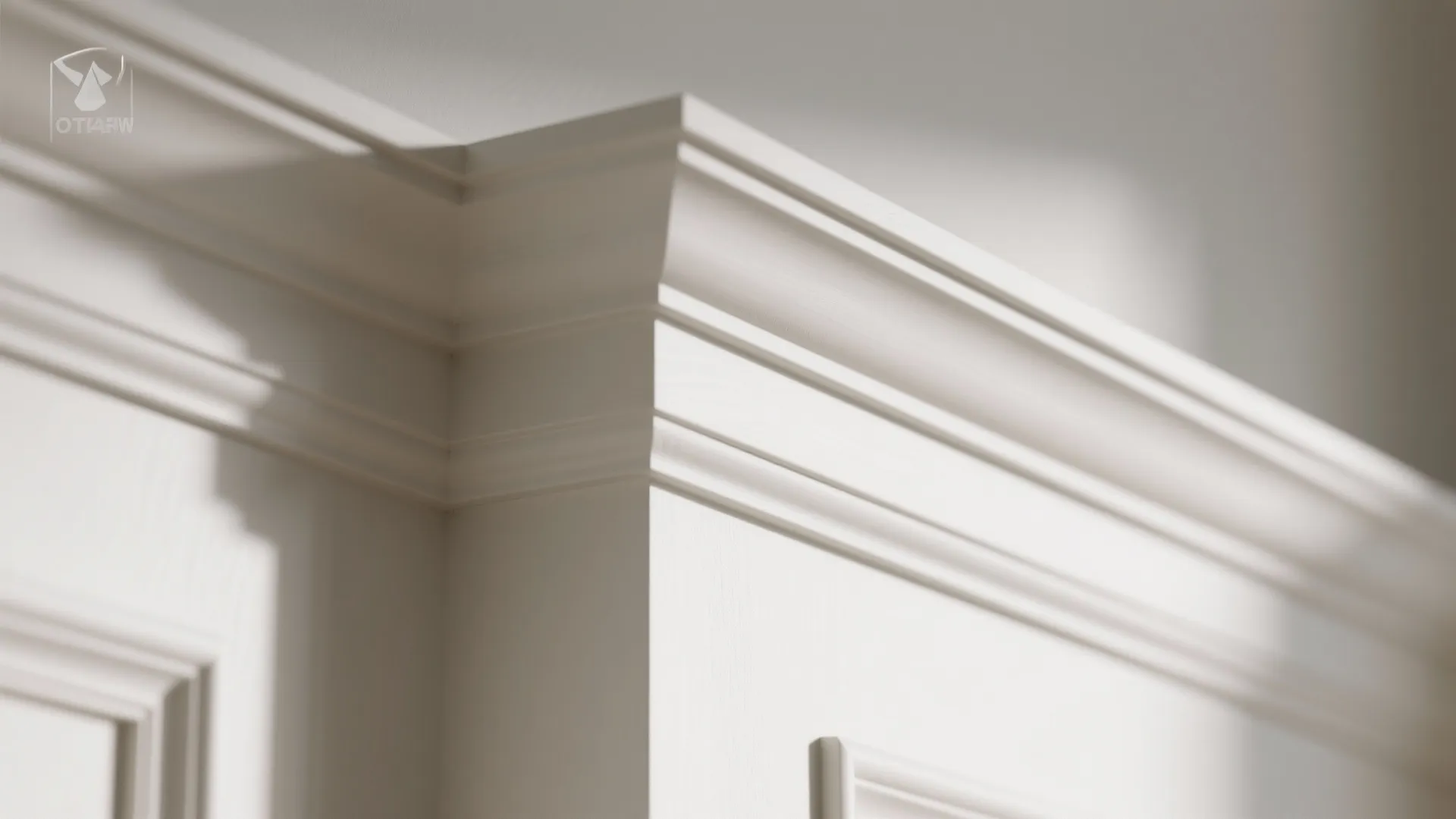 Close-up of layered crown molding showing a thin cove stacked with a flat band and crisp shadow lines.