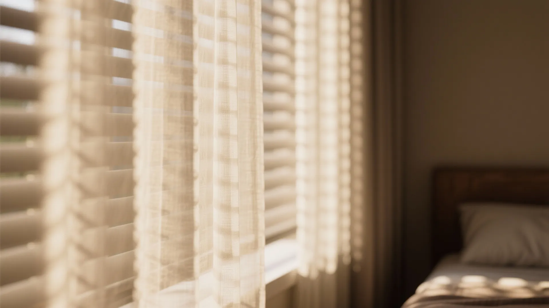 Sheer curtains layered over blackout blinds in daylight