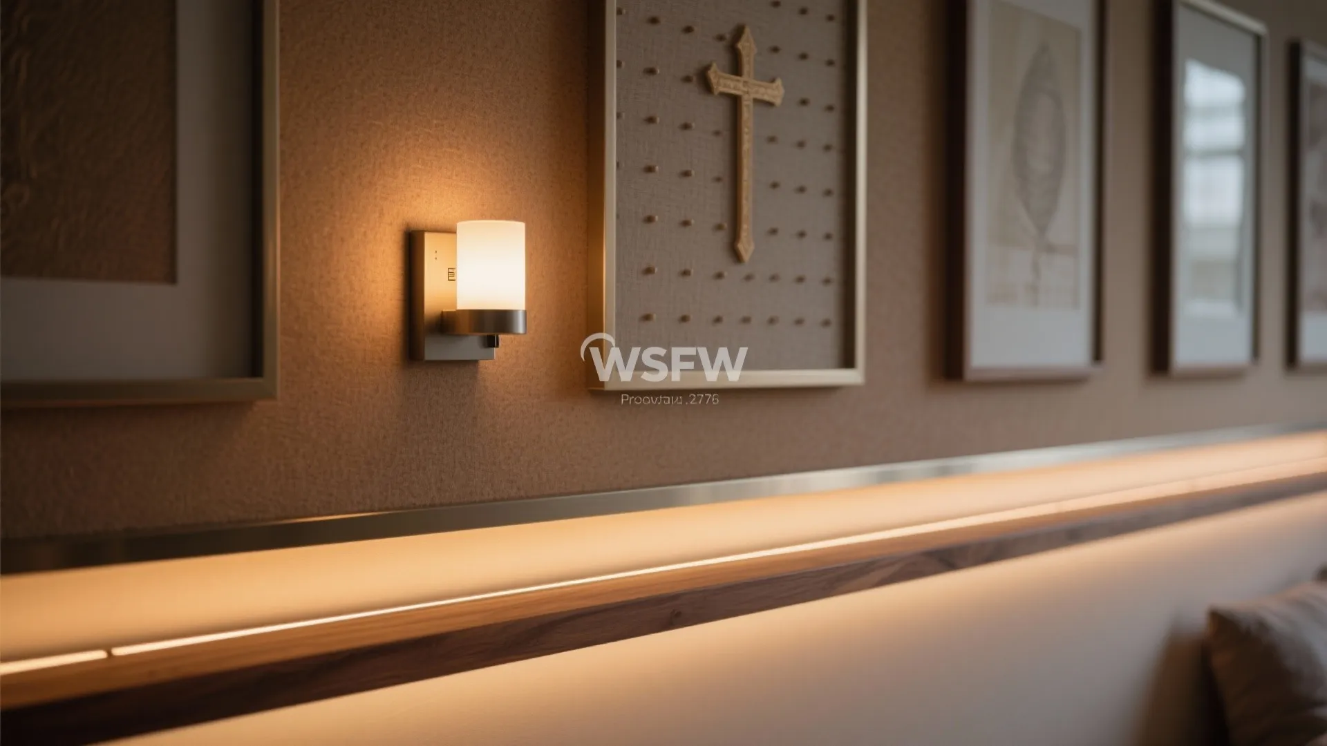 Small wall light next to a framed picture with a warm glowing hidden light strip