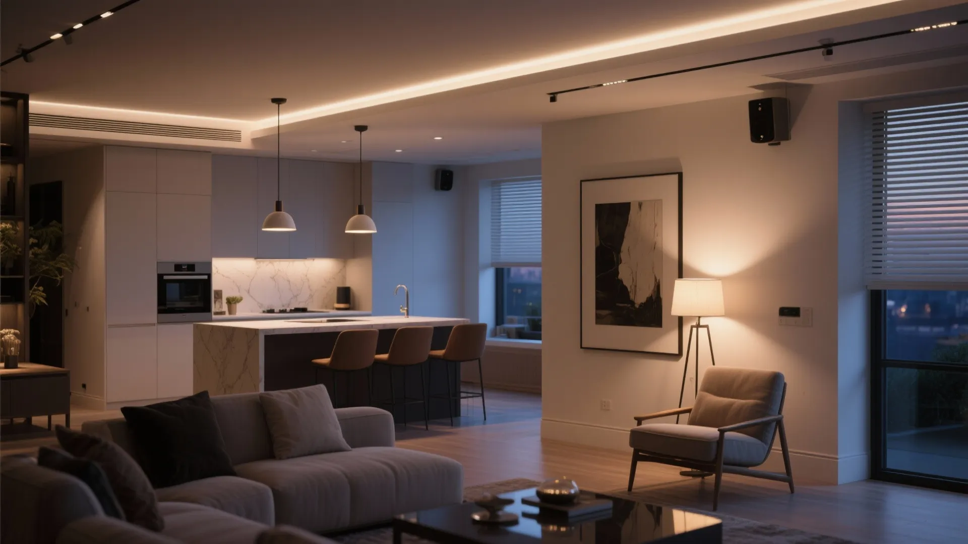 Open plan living room and kitchen featuring warm ceiling light floor lamp and grey sofa