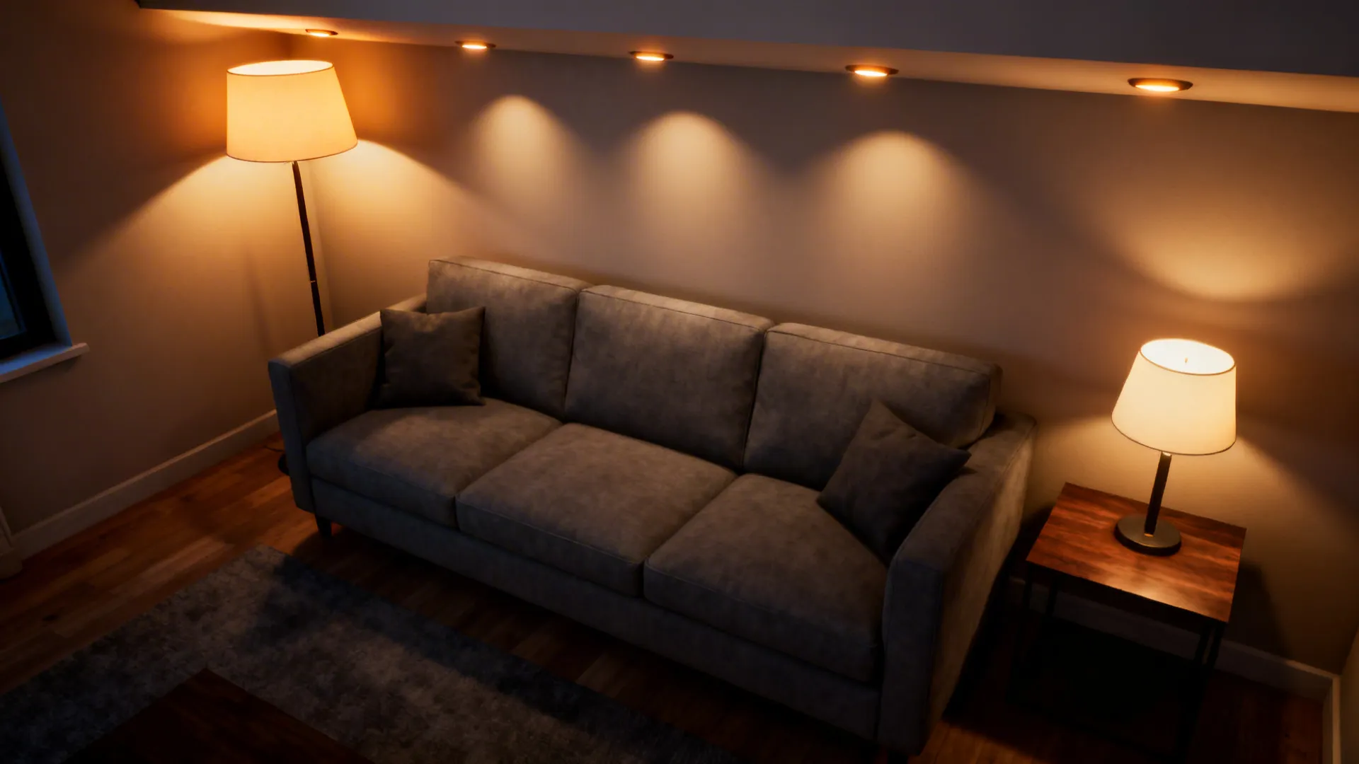 Layered lighting around a grey sofa with floor lamp, table lamp and recessed lights