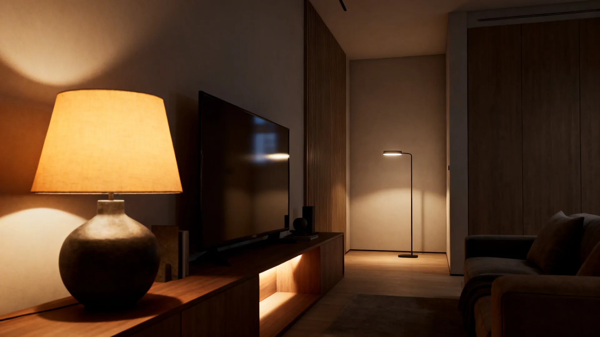 Layered lighting with a large table lamp near the TV and a slim floor lamp in the corner for depth.