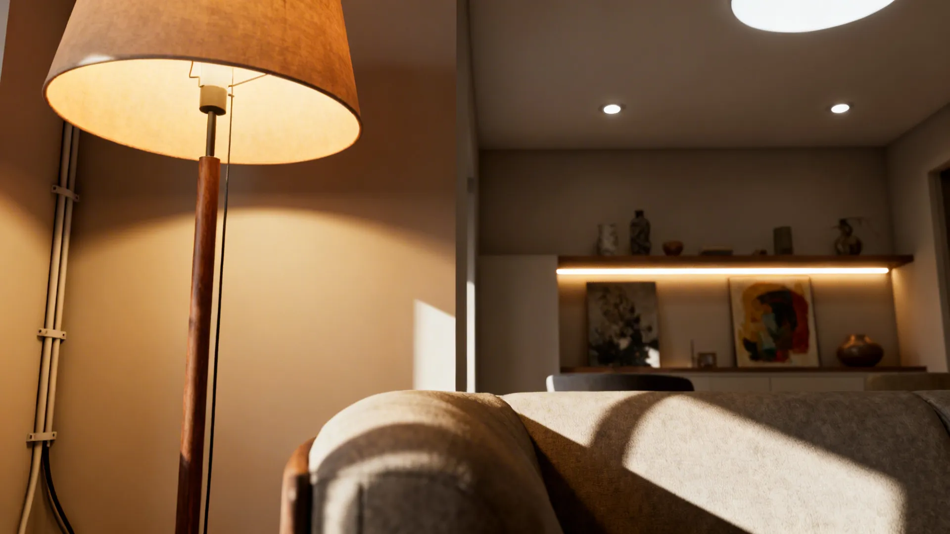 Close-up of layered lighting: floor lamp, recessed dimmers, and shelf accent lights in a small living room.