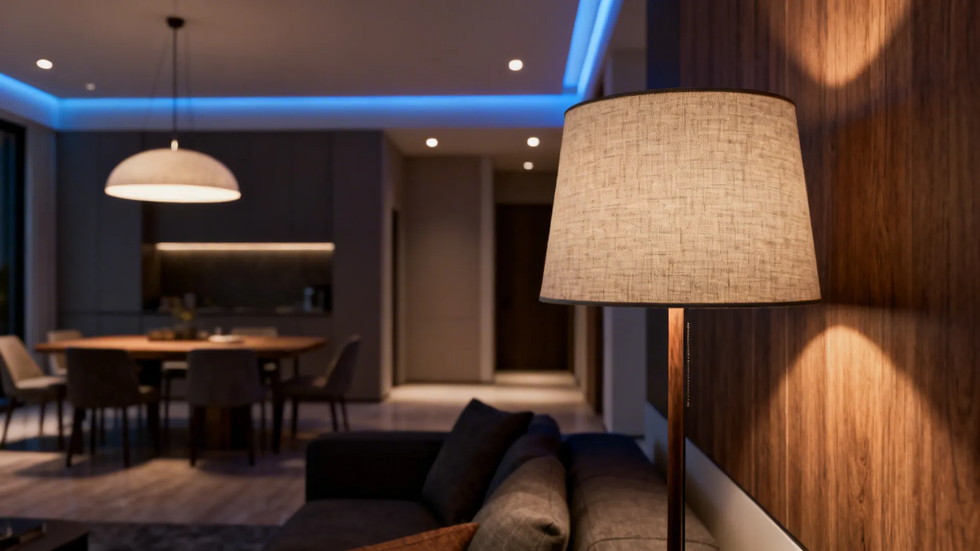 Detail of layered lighting: pendant, floor lamp, and recessed accents defining zones in an open-plan living area.