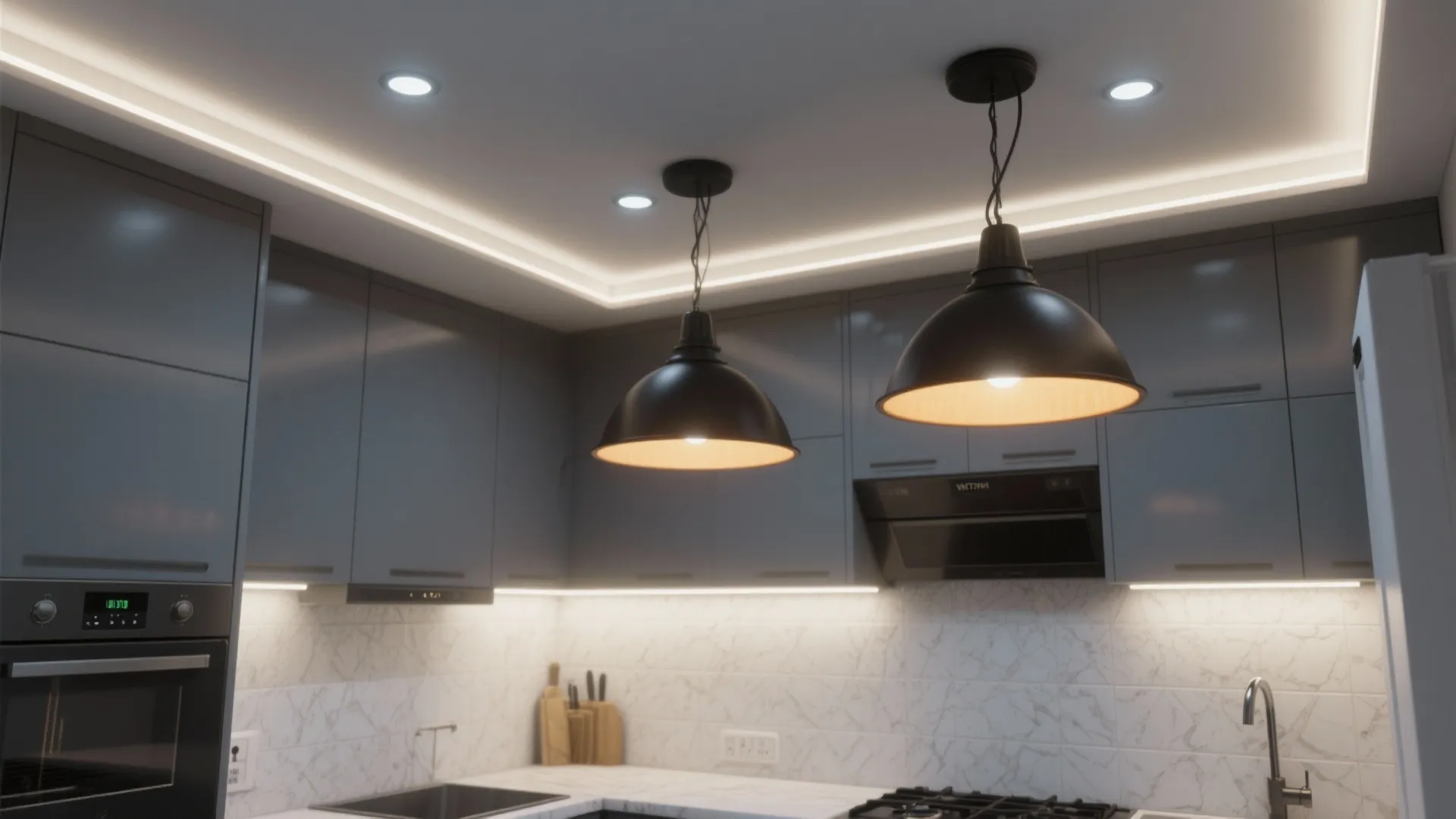 Layered lighting in a small grey kitchen showing under-cabinet strips, recessed lights and pendants.