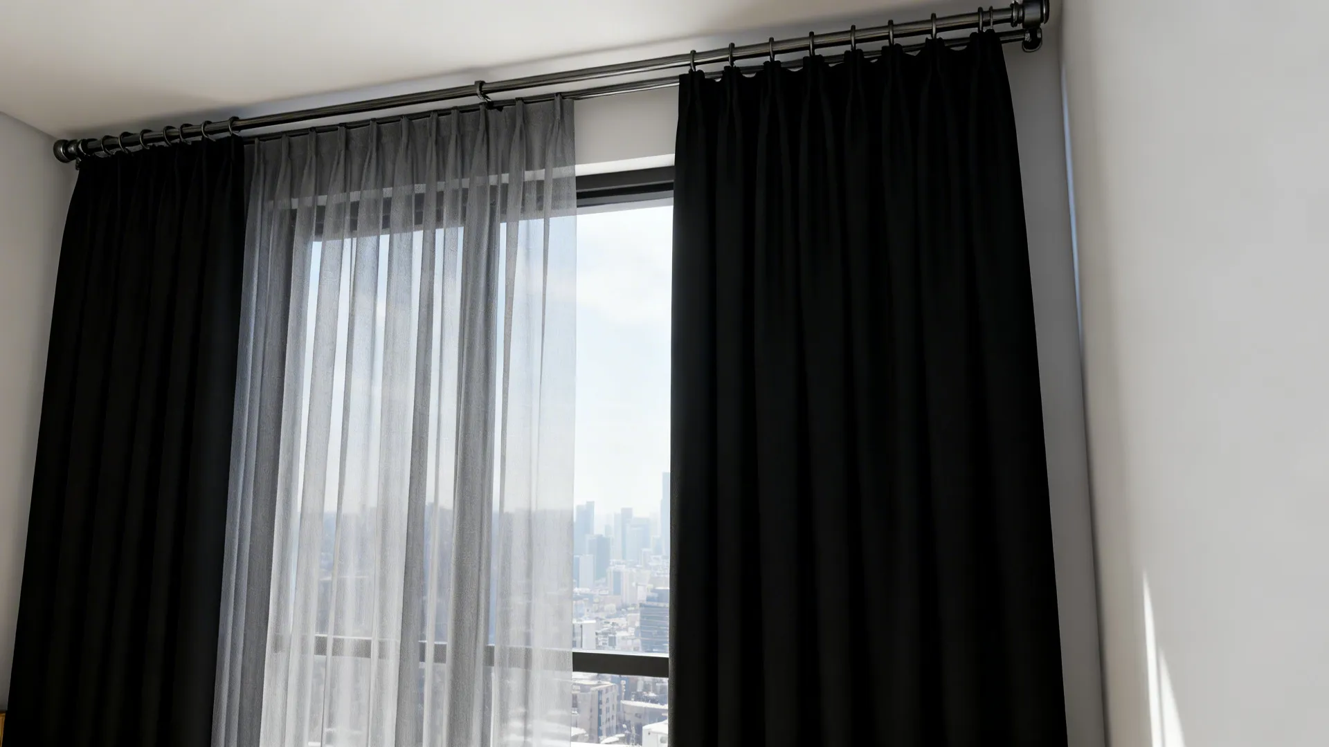 Narrow flat window with light grey sheer and black blackout panels on a double track