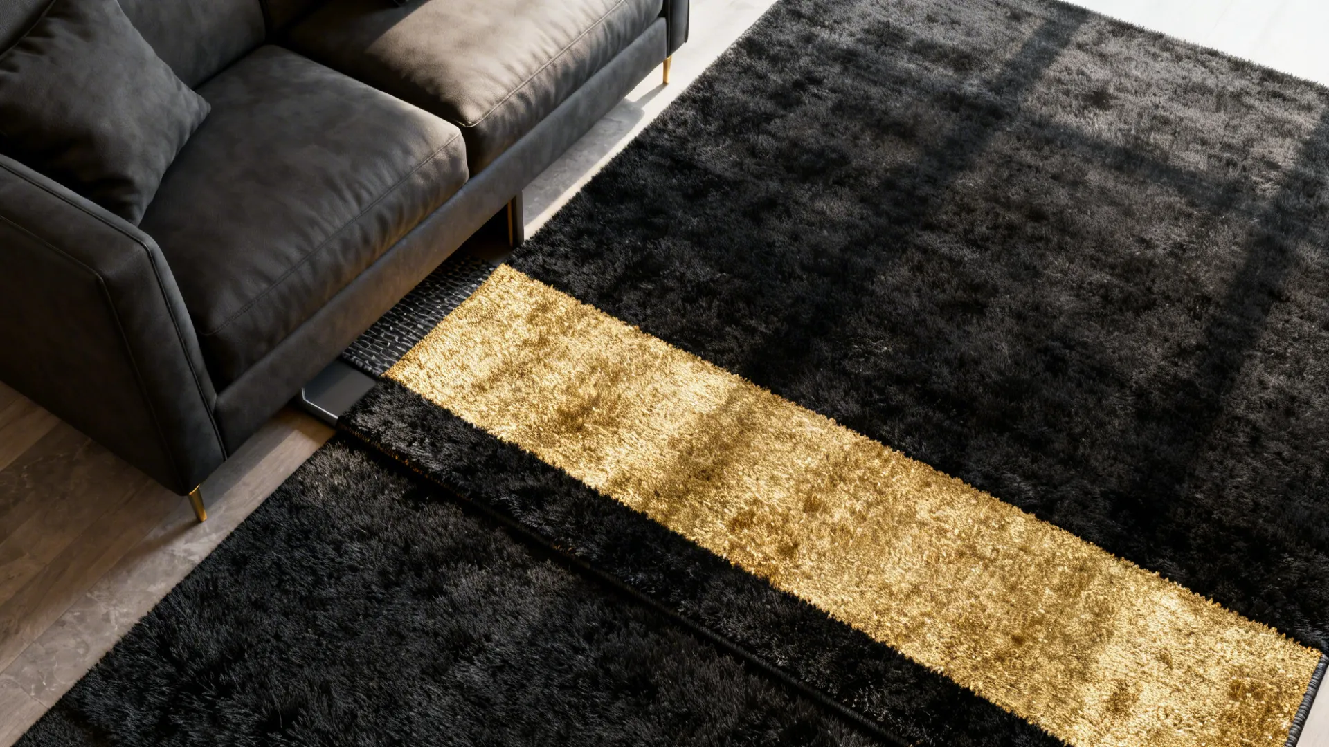 Top-down view of a low-pile black rug layered with a narrow gold-accent runner by the sofa.