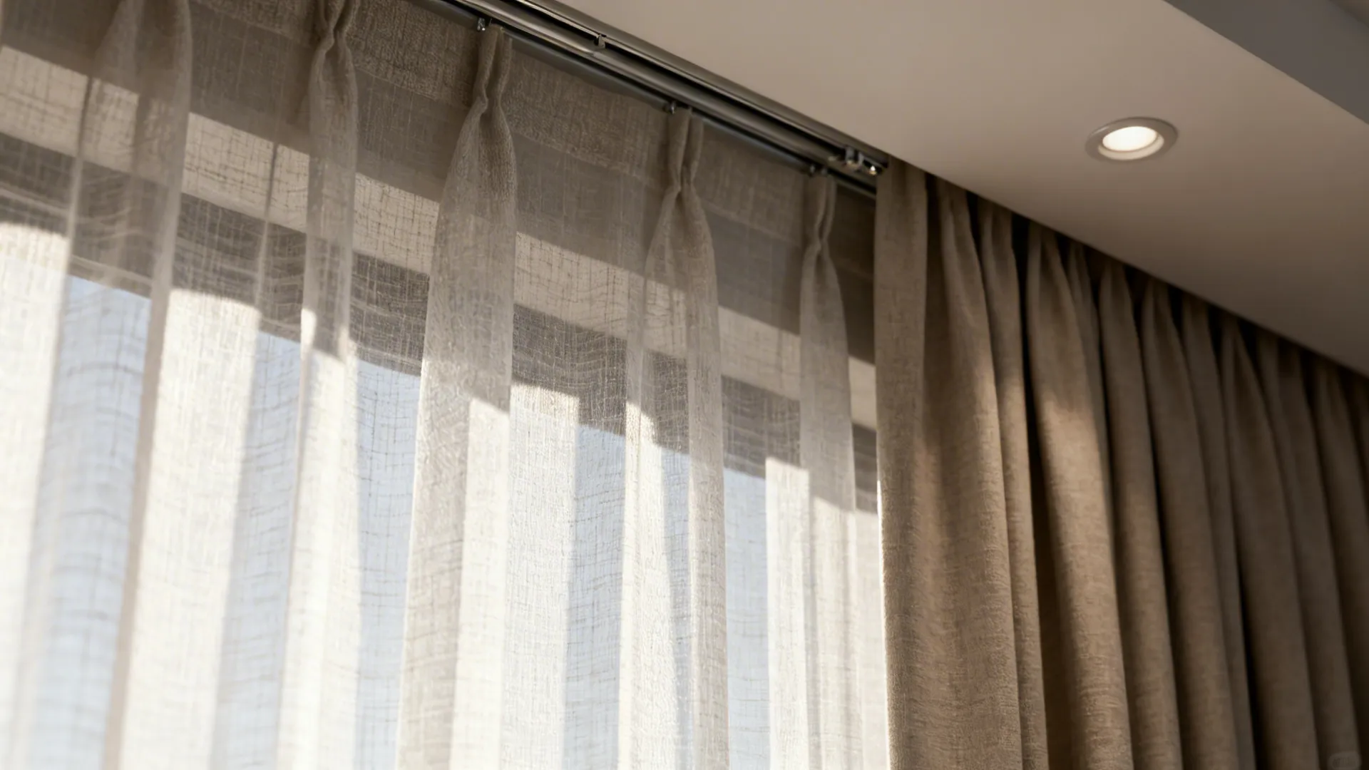 Close-up of sheer panel layered with a blackout drape on a recessed track