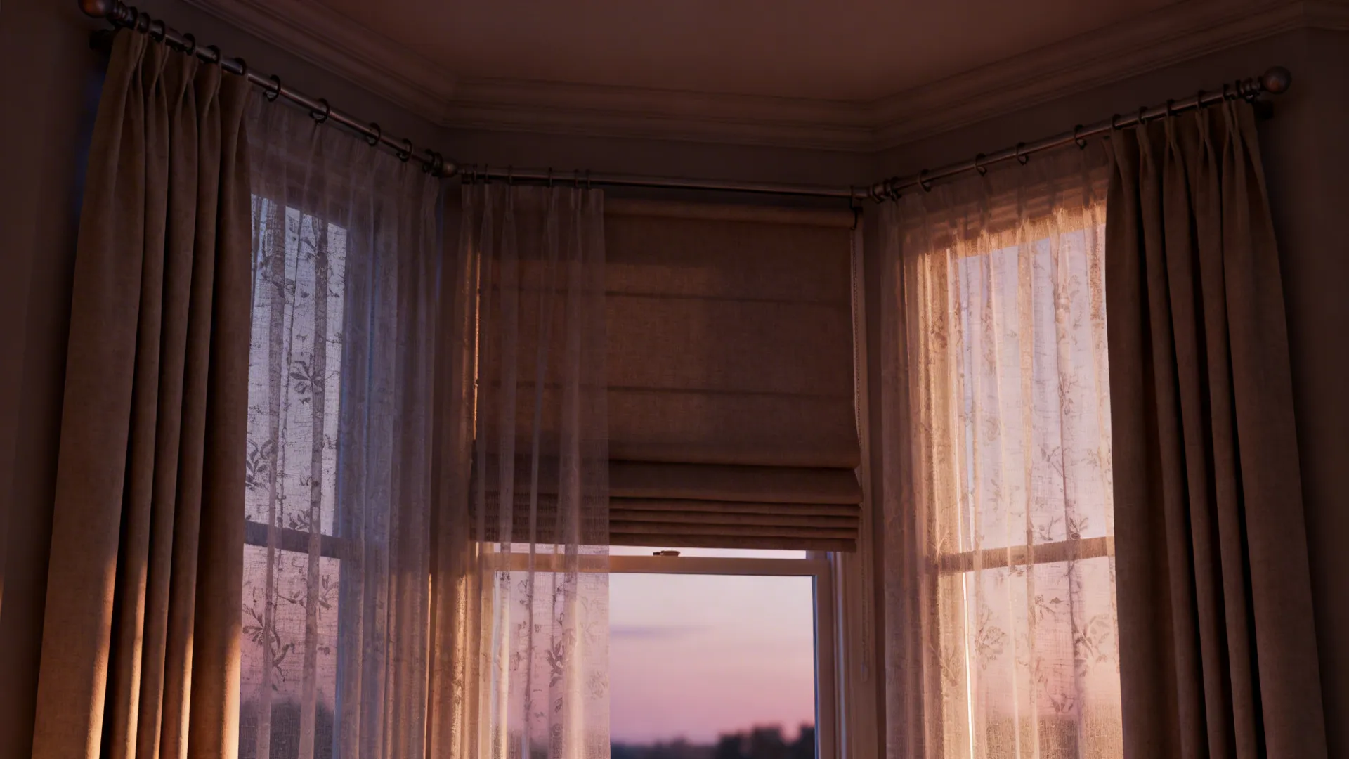 Layered sheer curtains with roman shades in a bay window controlling light and privacy